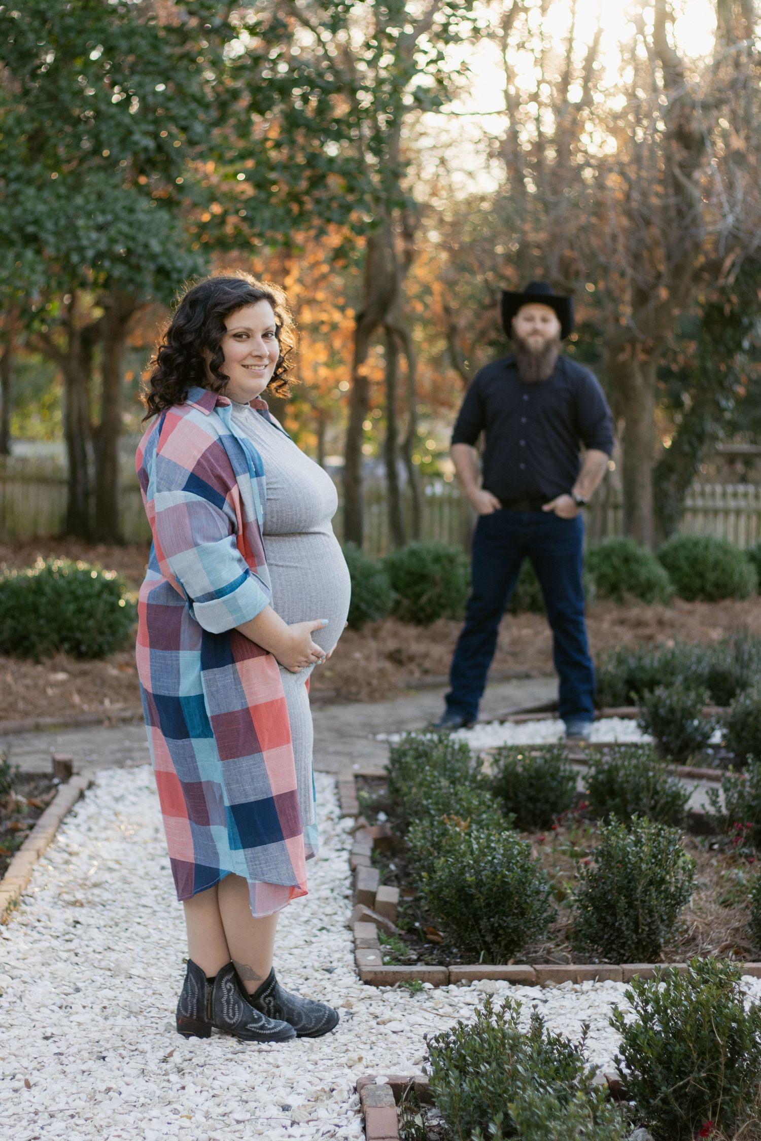 A series of outdoor portrait photos in a white stone garden pathway lined with shrubs during sunset.