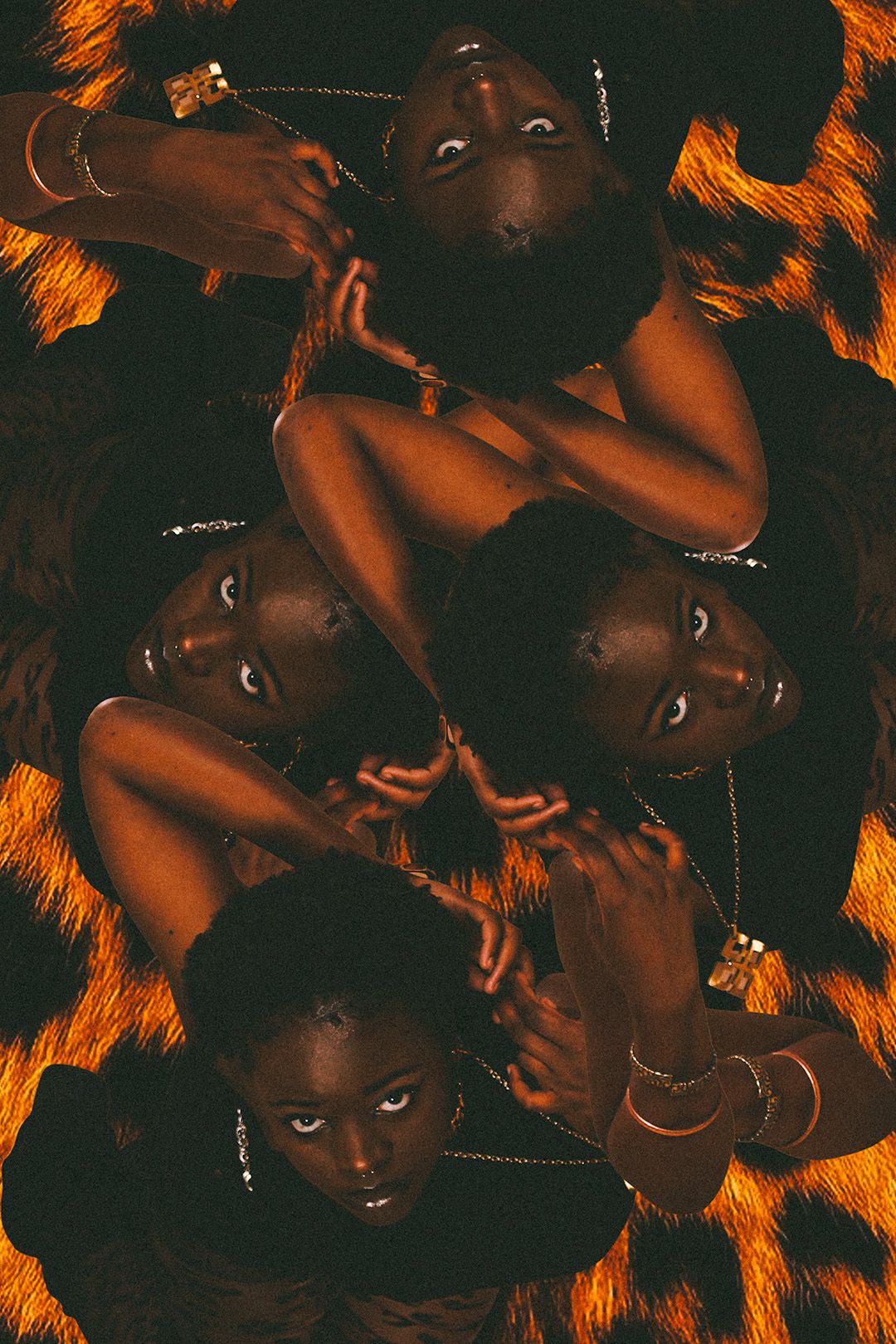 A creative mirrored collage of a dark-skinned woman lying on a leopard print background with gold jewelry.