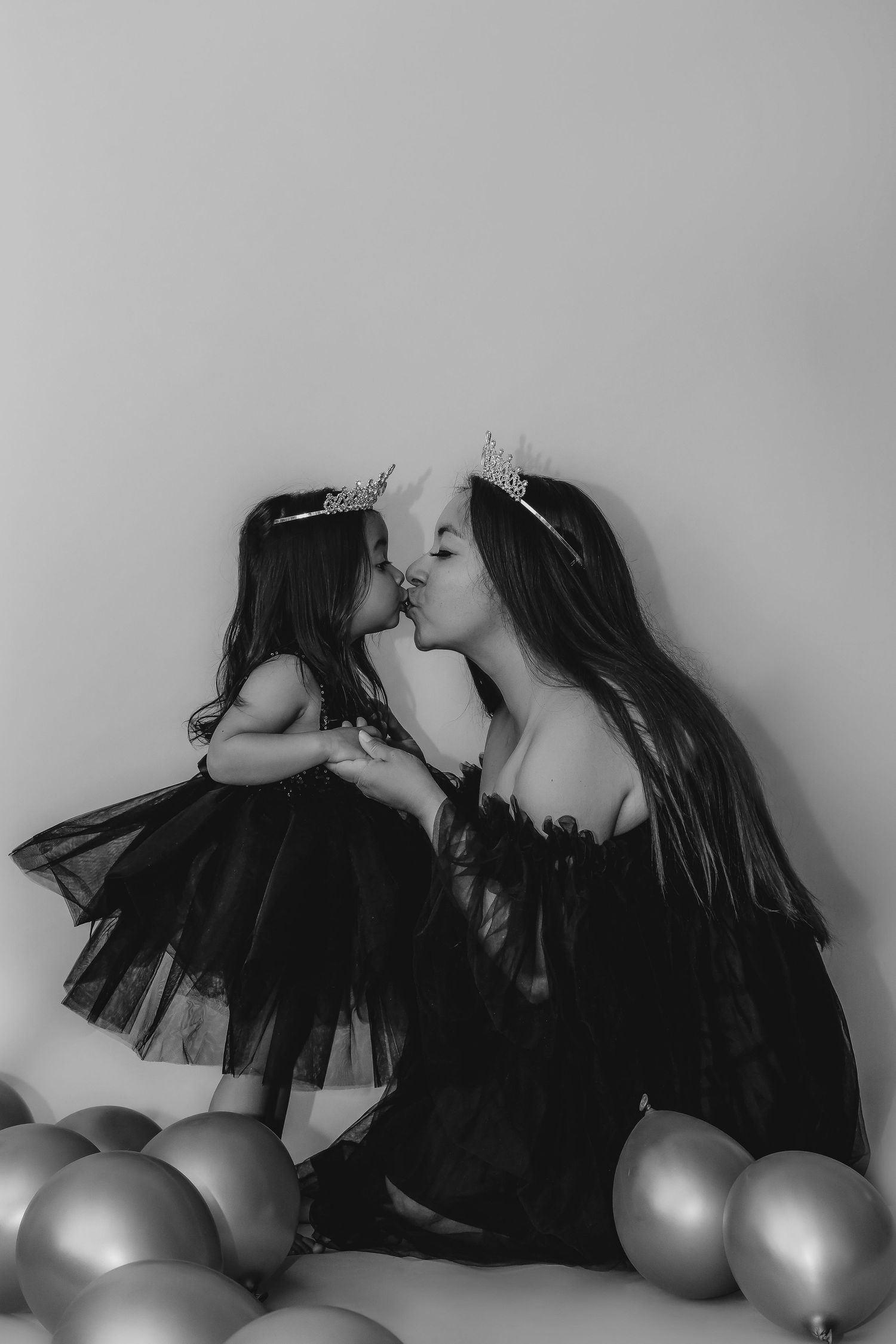 Mother and daughter embracing in a black-and-white fine art portrait, celebrating connection, love and family.