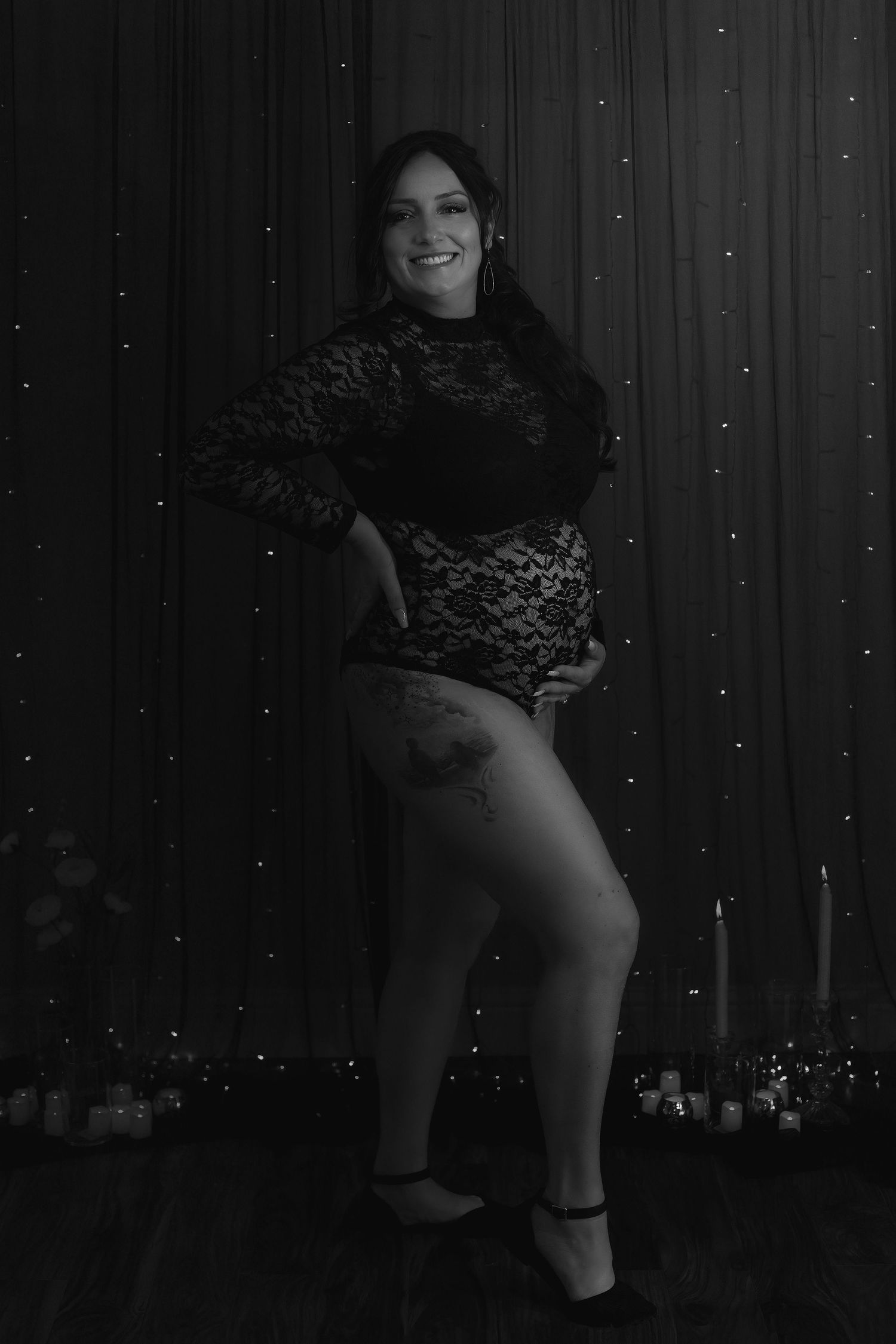 Black and white maternity portrait of a mother during a creative in-home photography session.