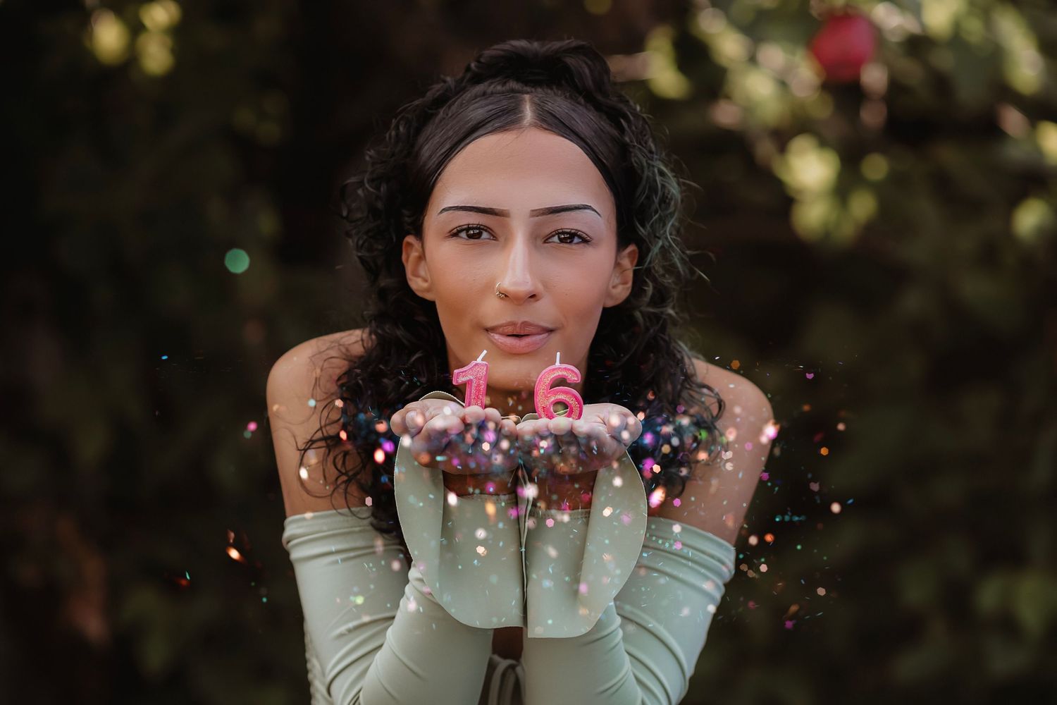 Portrait of a teenager blowing glitter toward the camera during an ethereal fine art Suite 16 photography session in Sonoma County.