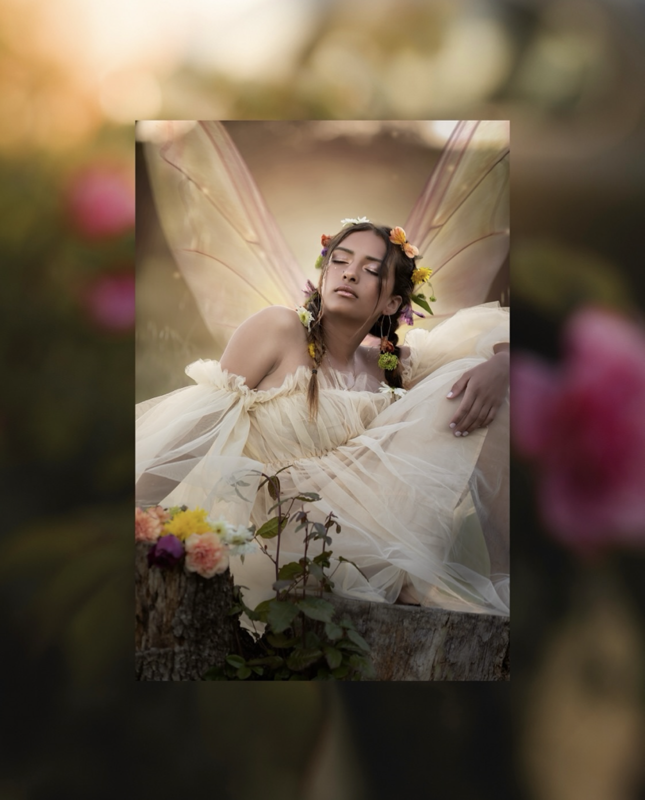 Whimsical portrait of young lady in flowing white dress surrounded by flowers during a fine art photography session.
