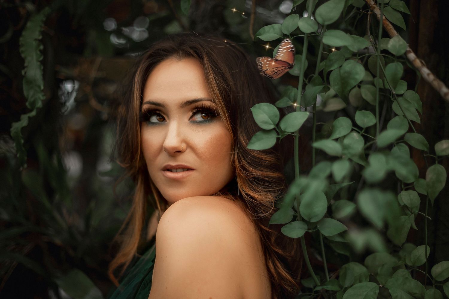 Fantasy-inspired portrait of Woman surrounded by greenery during a fine art photography session.