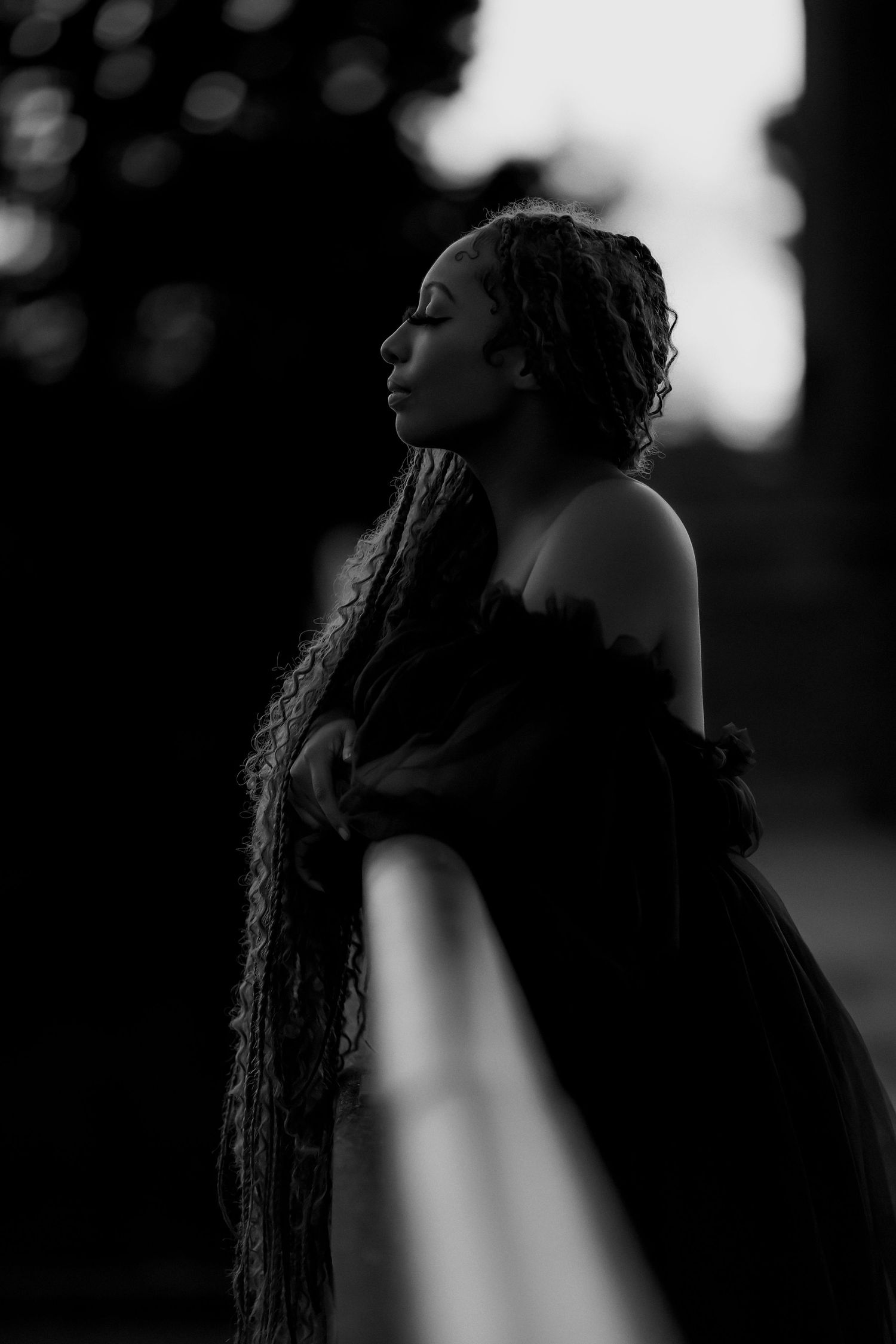 Fine art black and white portrait of woman with long braids during a creative portrait session in Sonoma County.