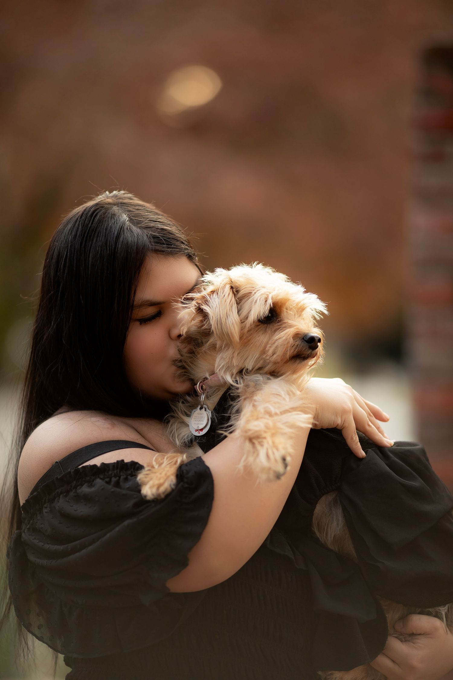 Woman holding her dog during an outdoor portrait session in Santa Rosa, California.