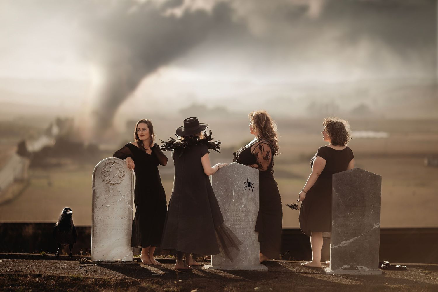 Creative fantasy portrait of women standing among historic gravestones with dramatic clouds and smoke effects in Petaluma, California.