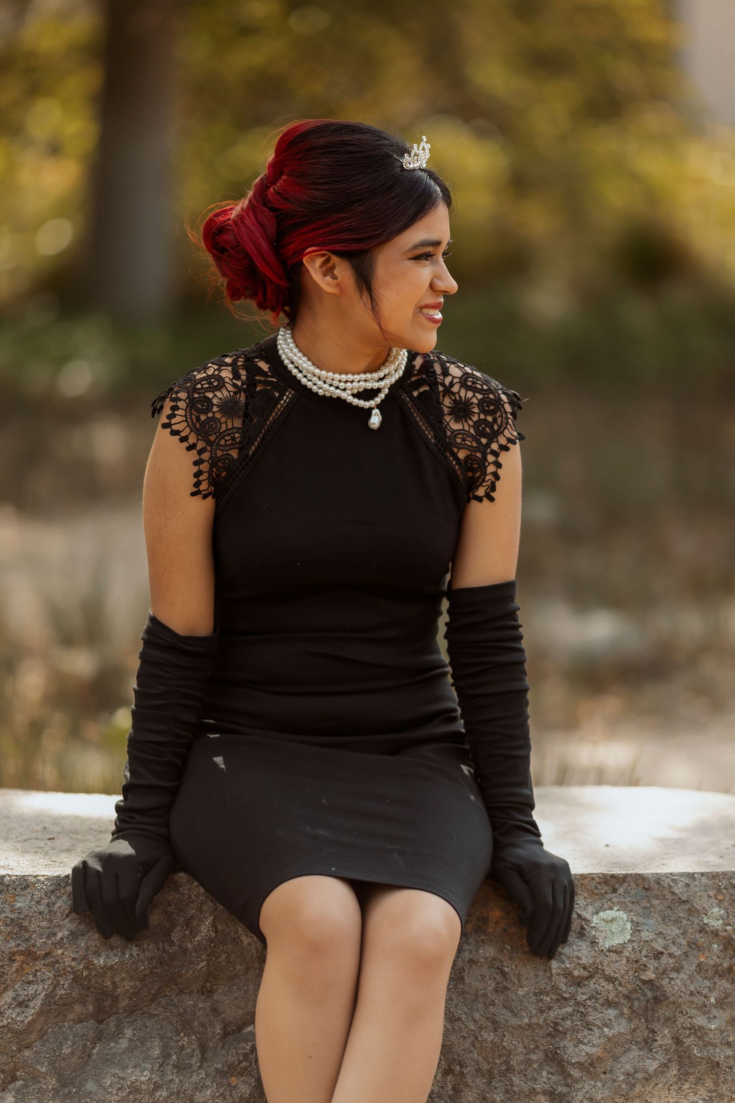 Stylized senior portrait of a young woman in a black dress with vintage inspired details photographed in Sonoma County