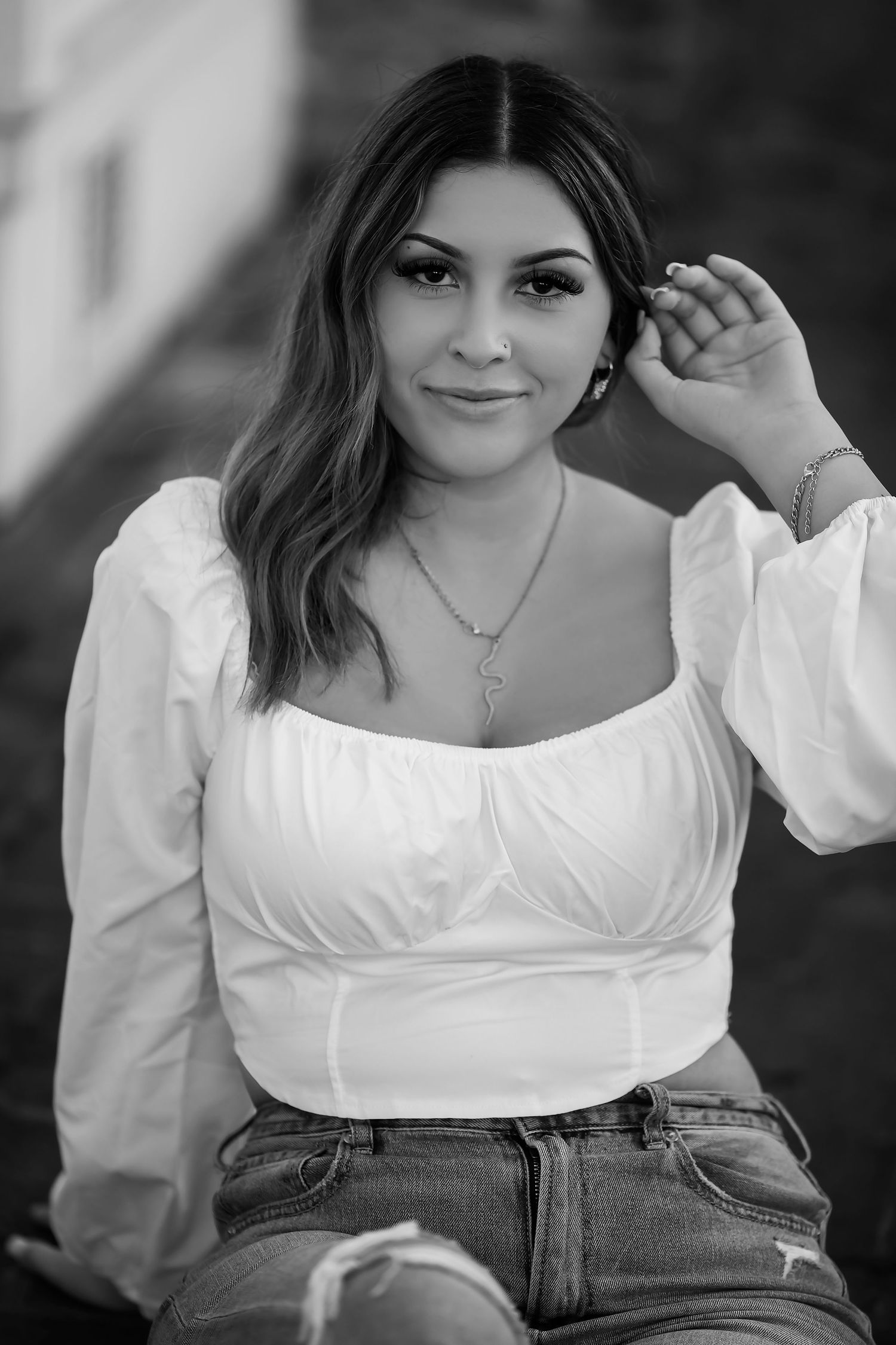 Black and white senior portrait featuring a young woman photographed with natural light and classic style