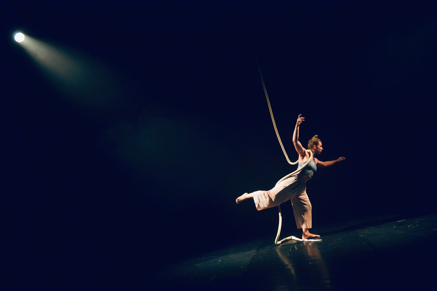 Adela Jordakova on stage in the static pose with lights illuminating her