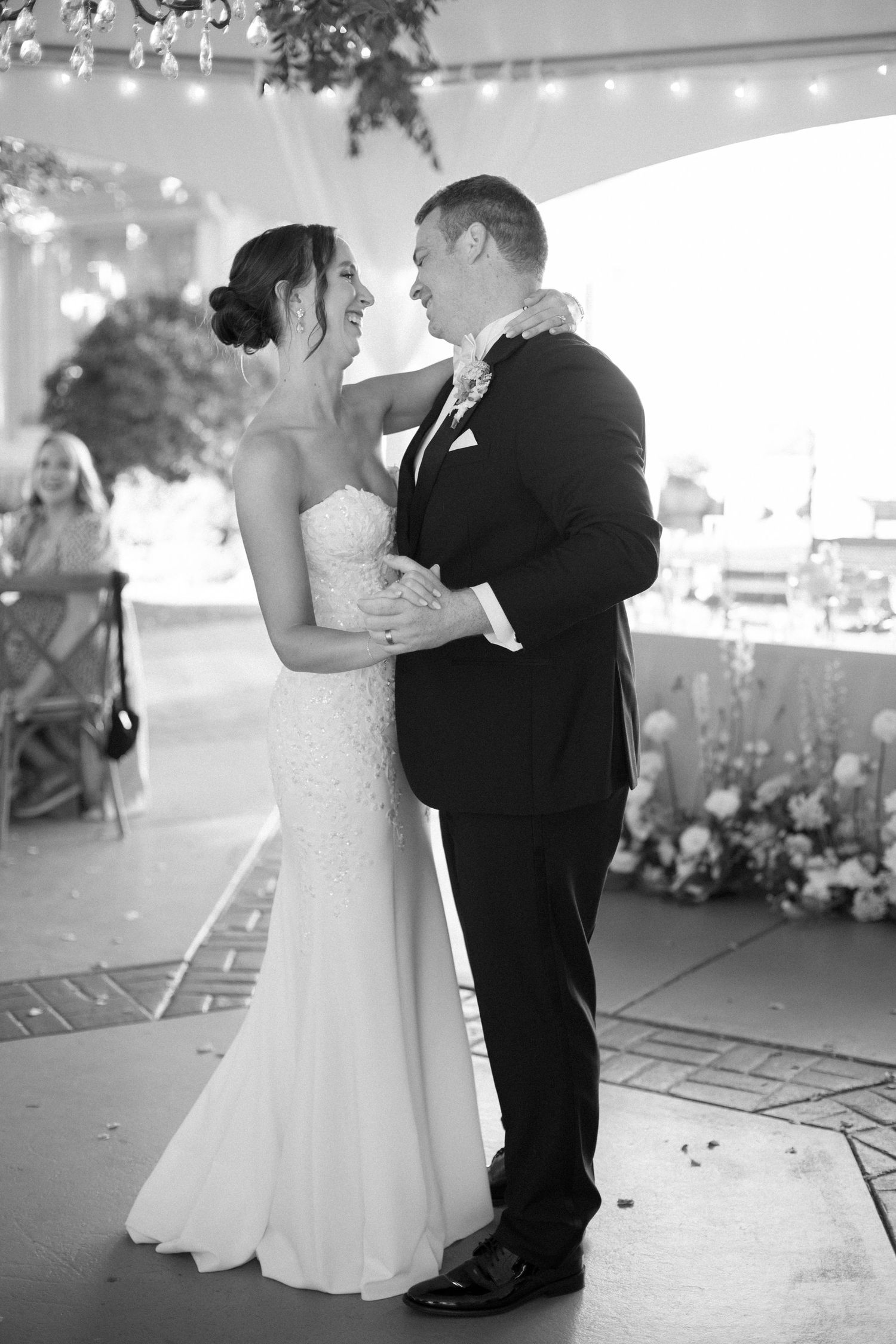 Black and white photos of a couple's first dance at their wedding reception.