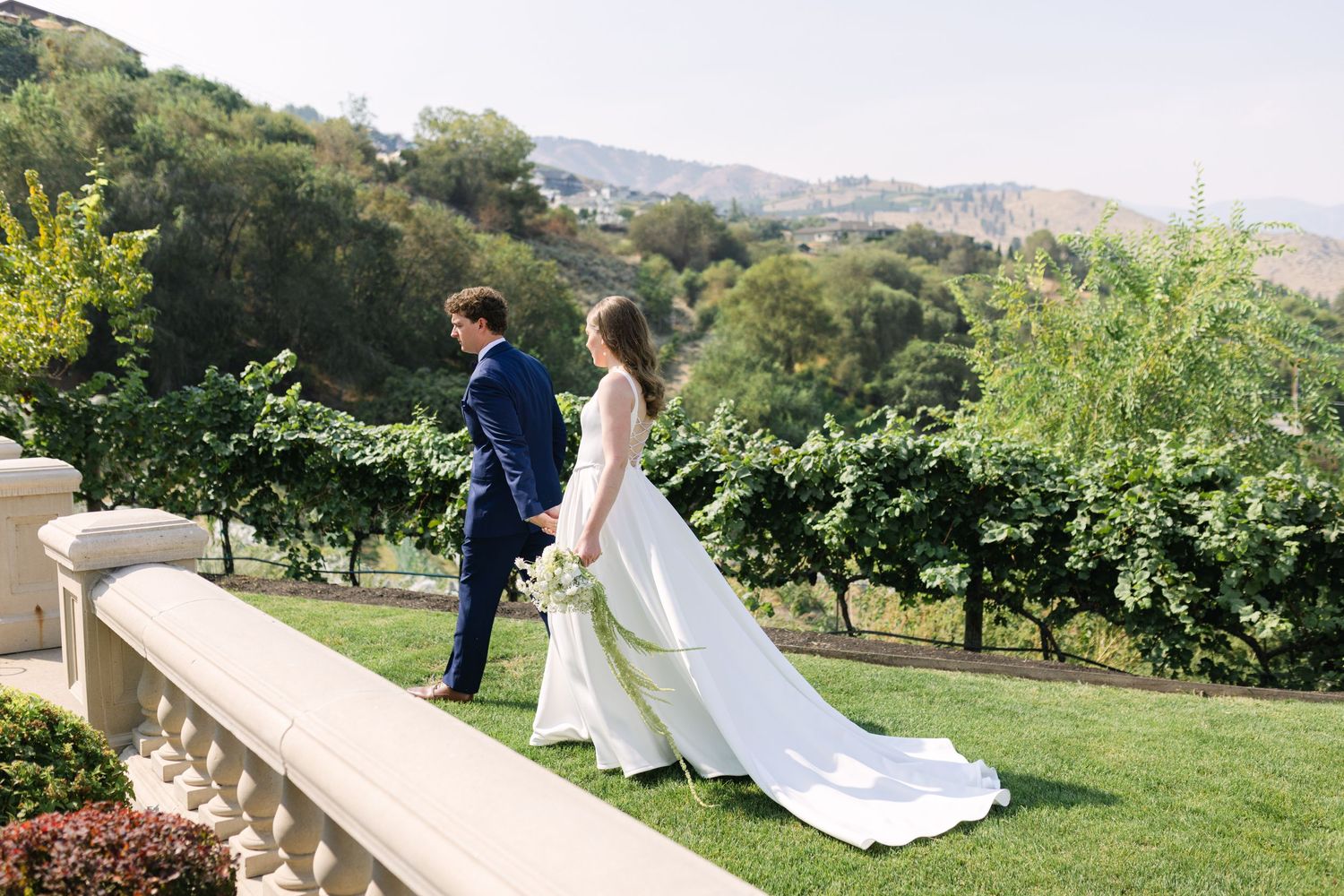 Elegant outdoor wedding ceremony on a terrace with mountain views and lush greenery.
