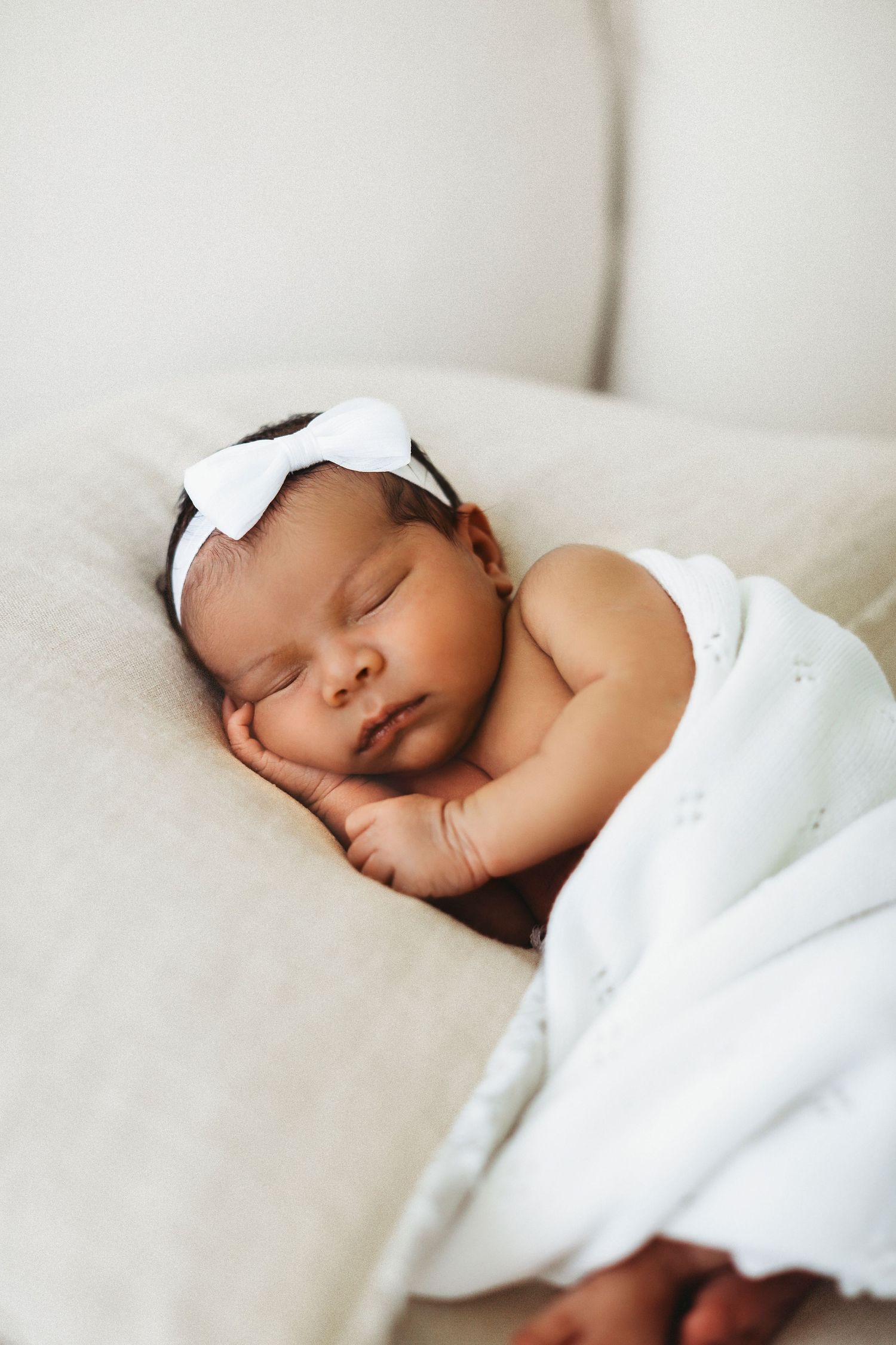 Newborn baby wrapped in knit blanket during studio session in Modesto, California Newborn Photographer