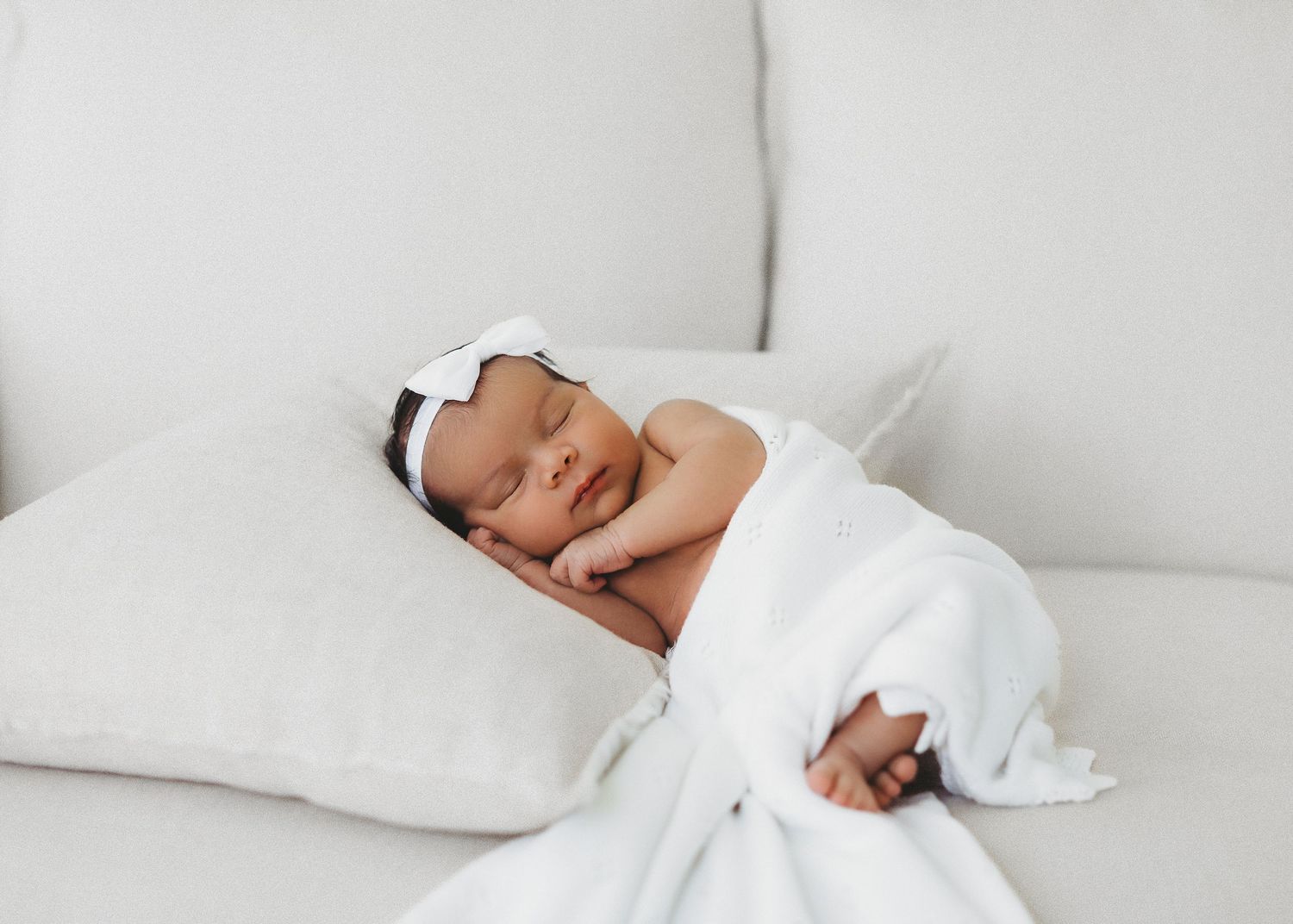 Newborn baby wrapped in knit blanket during studio session in Modesto, California  Newborn Photographer
