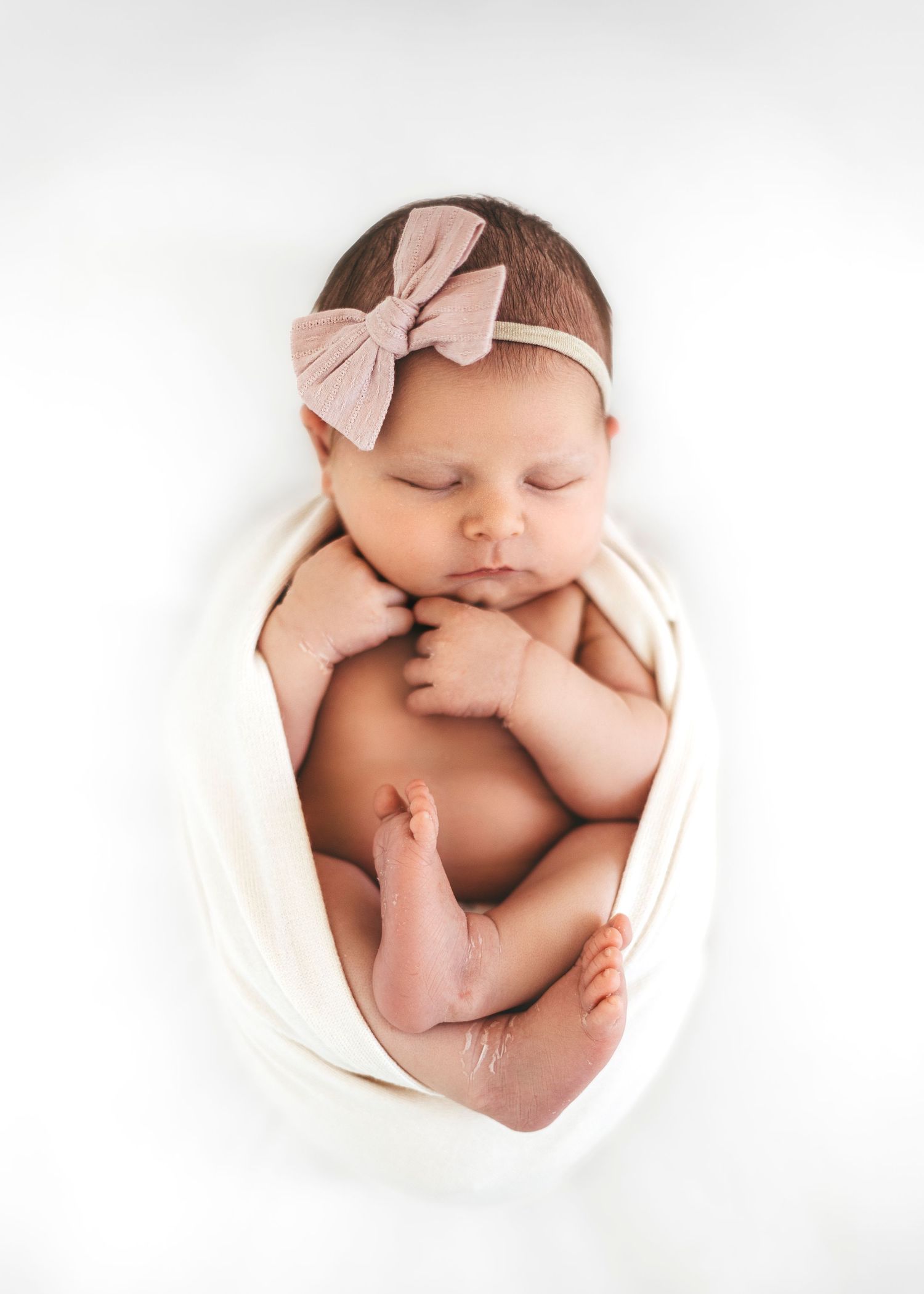 Newborn baby wrapped in knit blanket during studio session in Modesto, California Serving Modesto + Central Valley