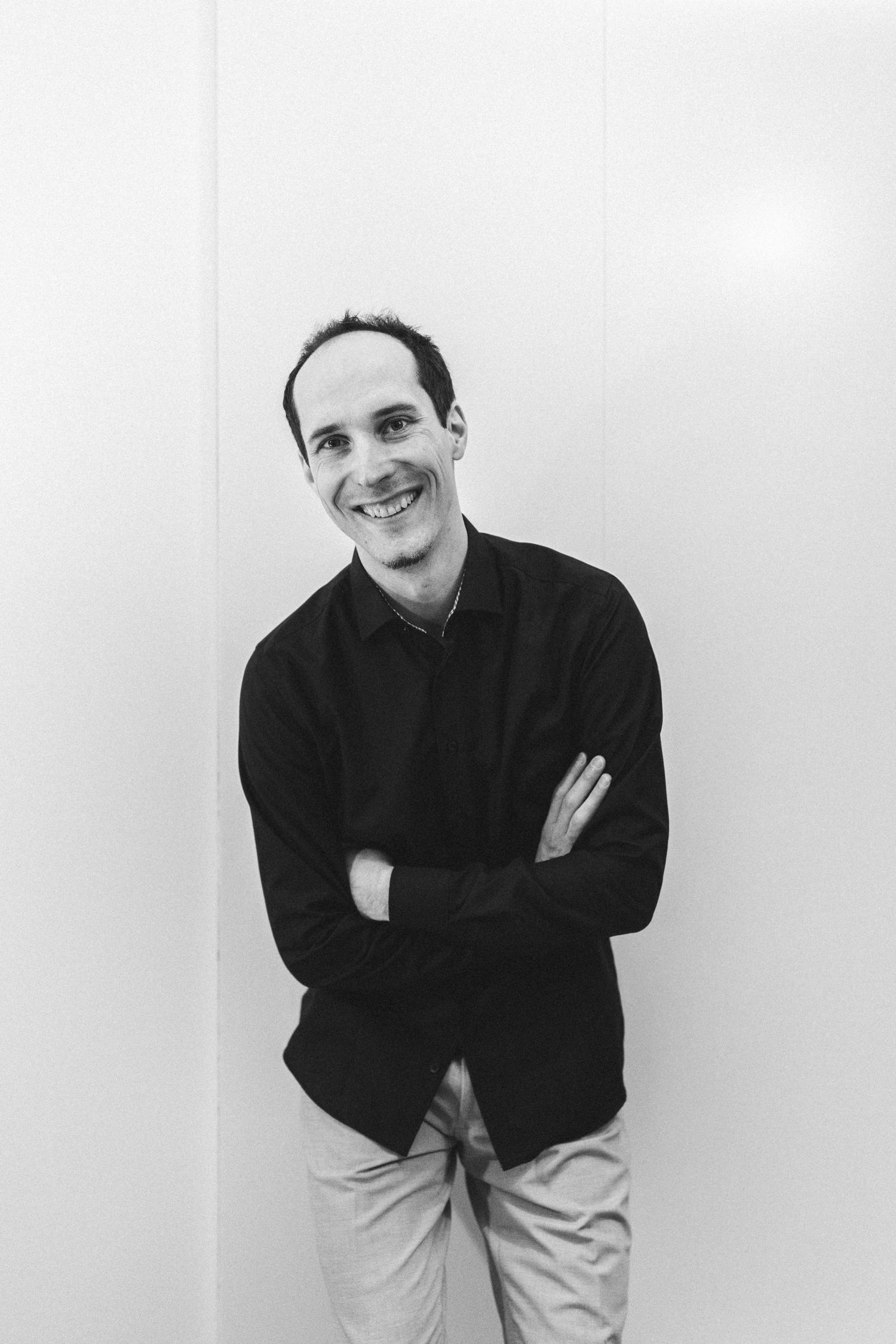 Black and white portrait series showing a person in dark clothing against a white background.