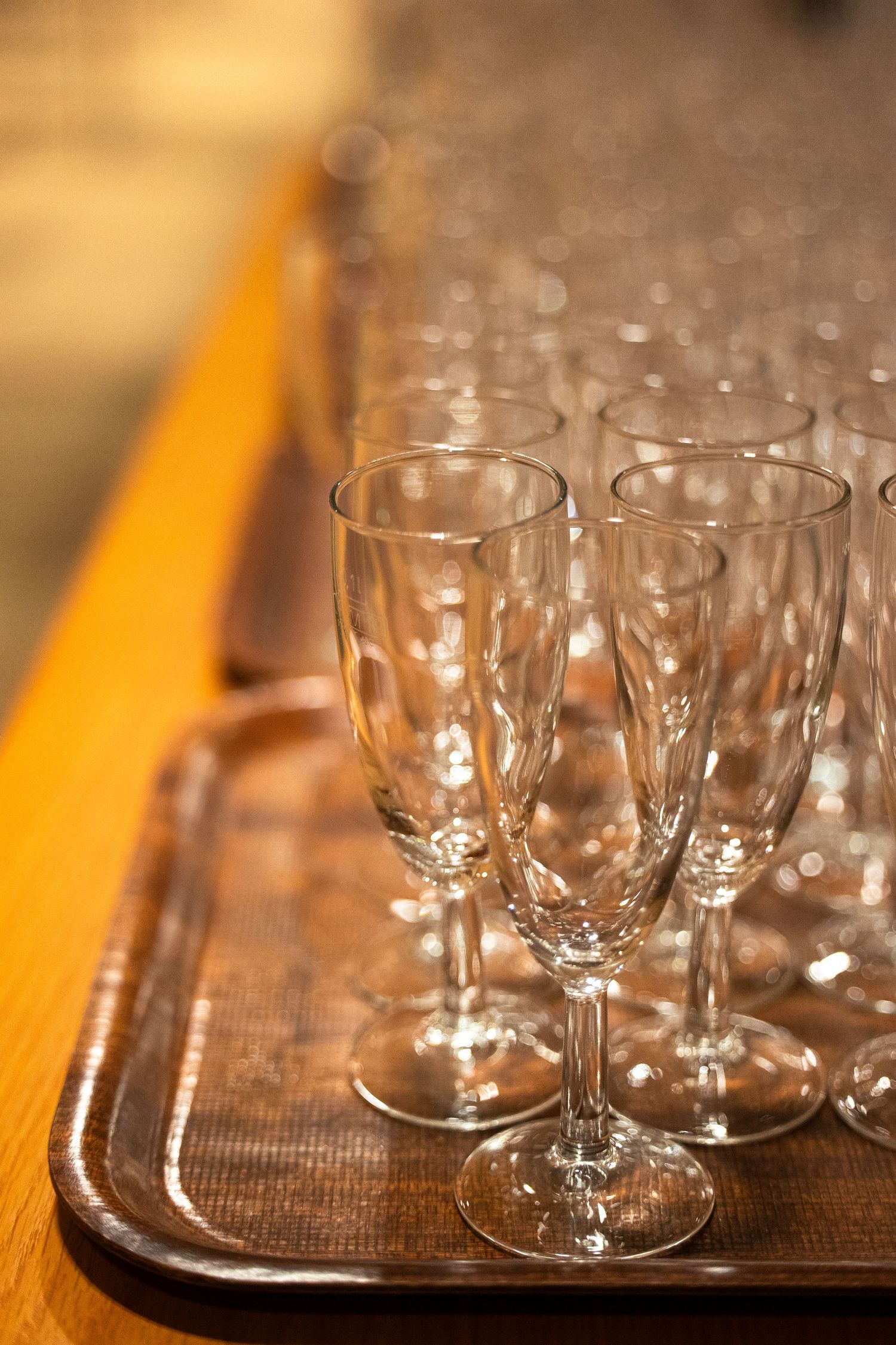 Empty crystal champagne flutes arranged on a silver tray, ready for a celebration or formal event.