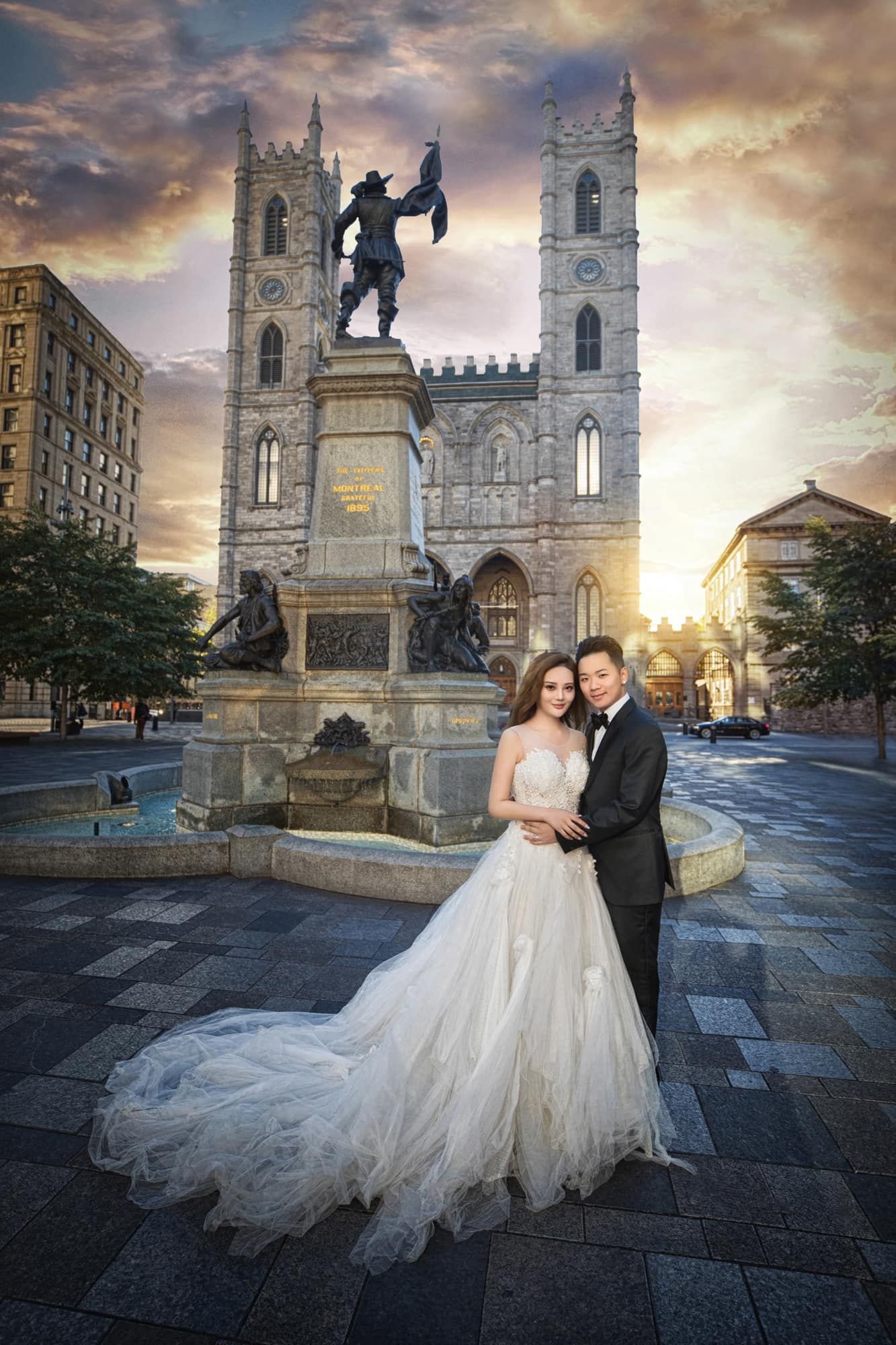 Wedding couple posing before Notre-Dame Basilica Montreal at golden sunset in elegant formal attire.
