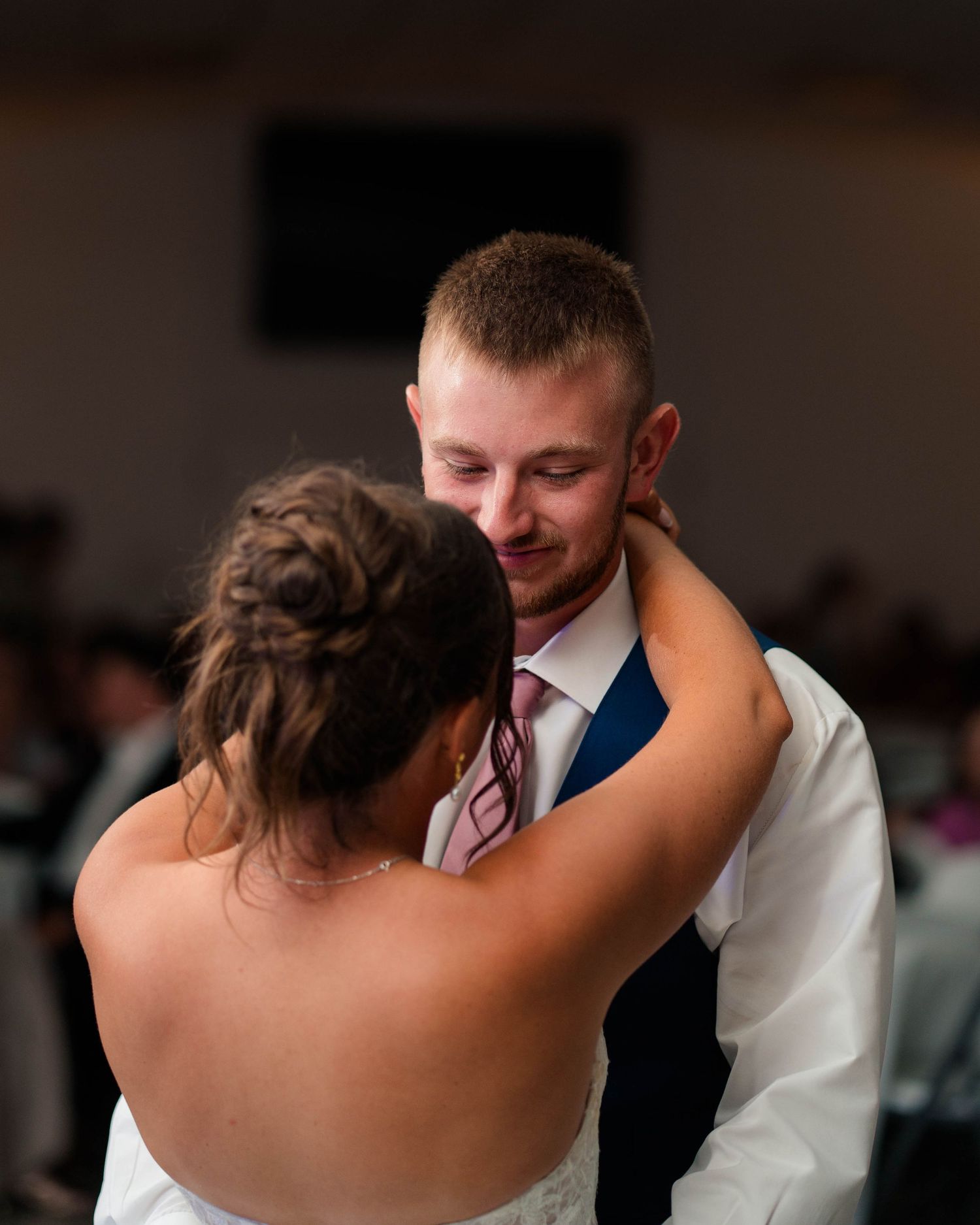 Groom gazes lovingly at his bride during their first dance at their wedding reception.