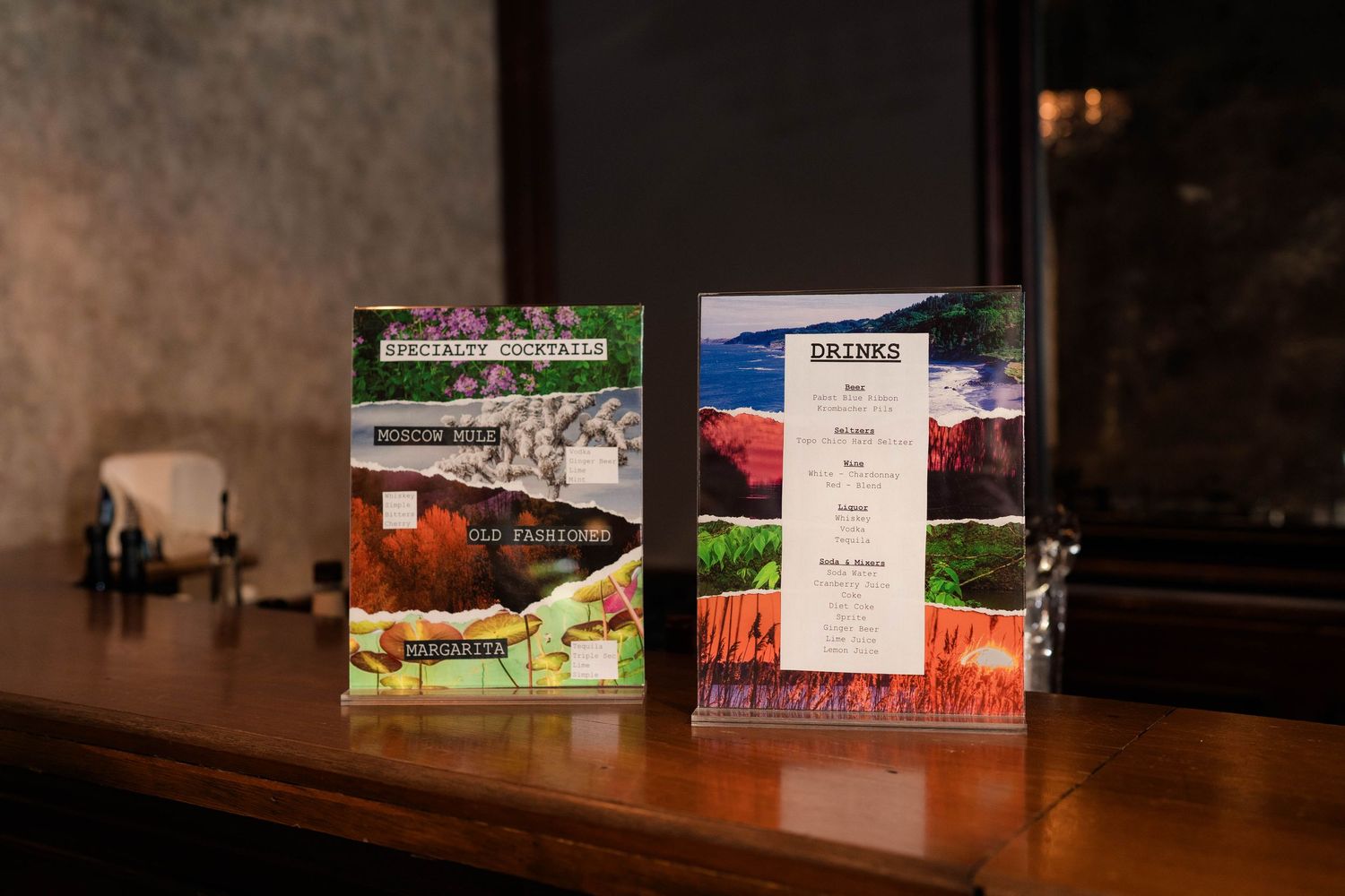 Two decorative menus displayed on wooden table at elegant wedding reception venue.