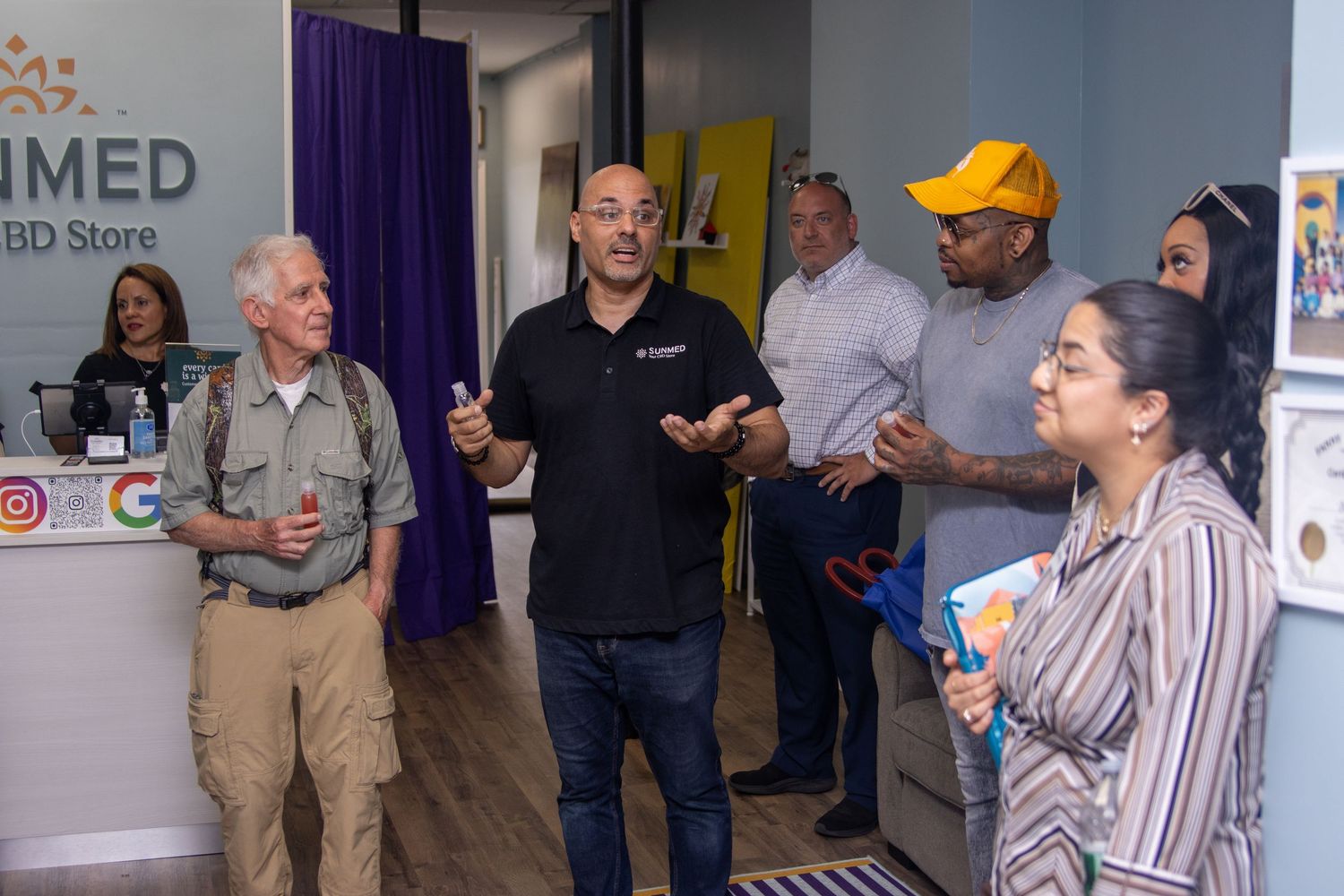 Man speaking to a small group inside a CBD store during a business presentation.
by Andrew Fein Photography - Family and Newborn Photo