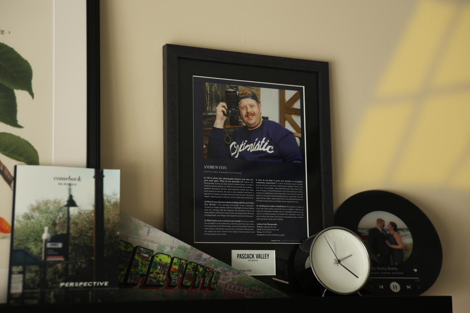 Framed photographer portrait displayed on a shelf beside a clock and vinyl record decoration.
by Andrew Fein Photography - Family and Newbor