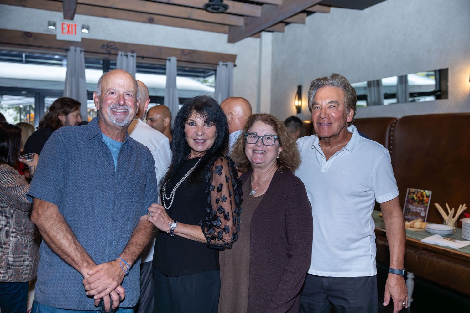 Four adults smiling together at a casual indoor social gathering.
by Andrew Fein Photography - Family and Newborn Photo