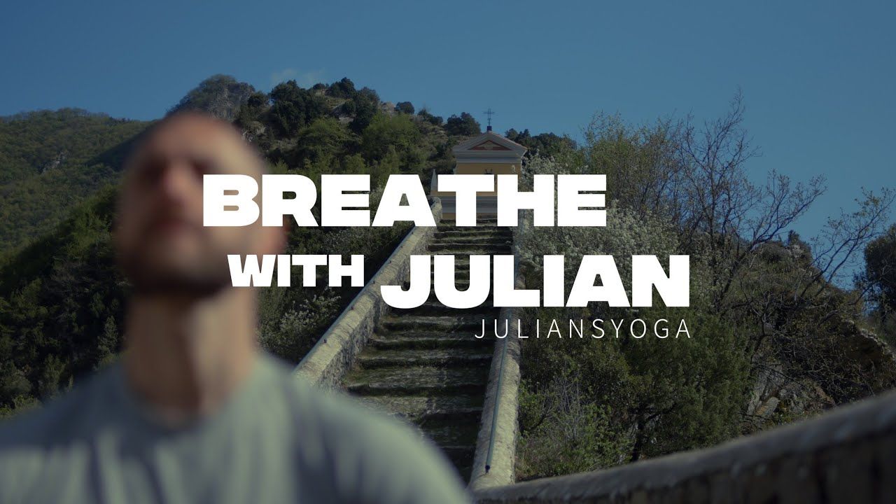 Man standing outdoors with text overlay reading Breathe With Julian JuliansYoga.