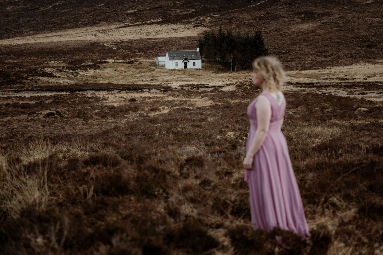 Moody landscape photograph of rugged brown moorland terrain with dramatic lighting and atmosphere.