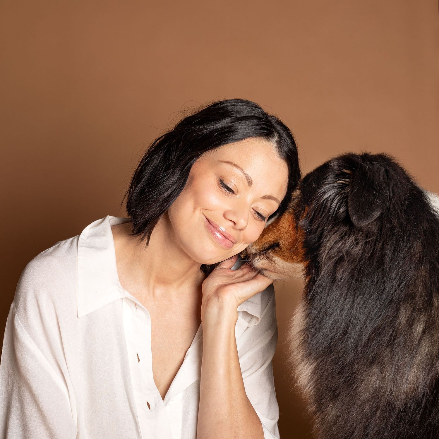 Woman cuddles dog