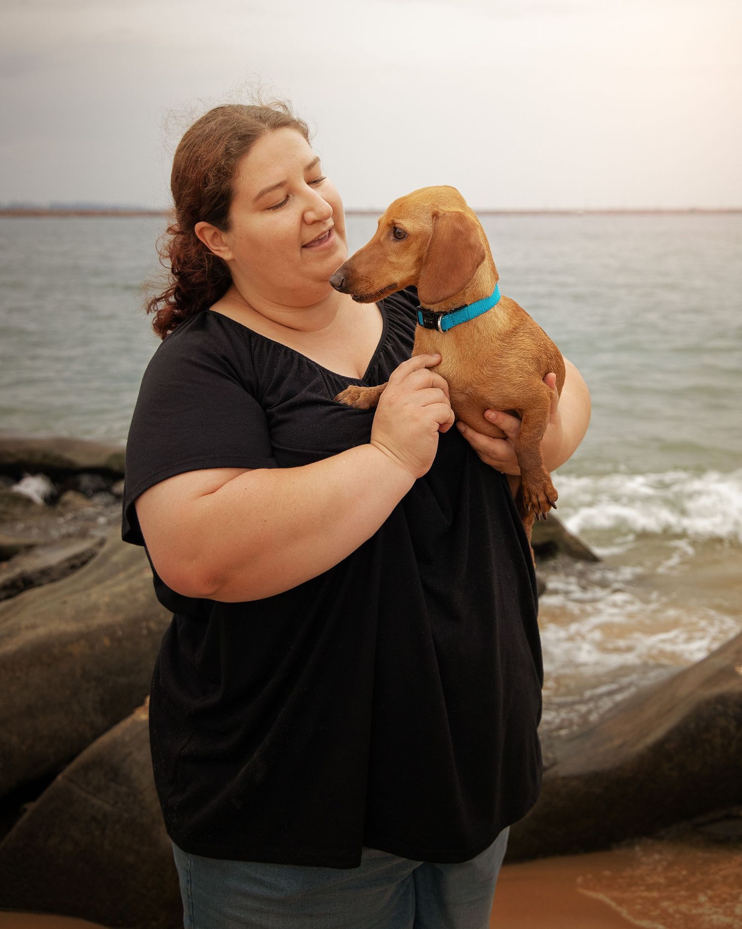 Woman with dog on beach