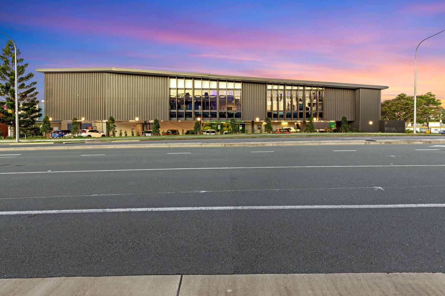 Exterior photograph of the Coomera commercial building at dusk.