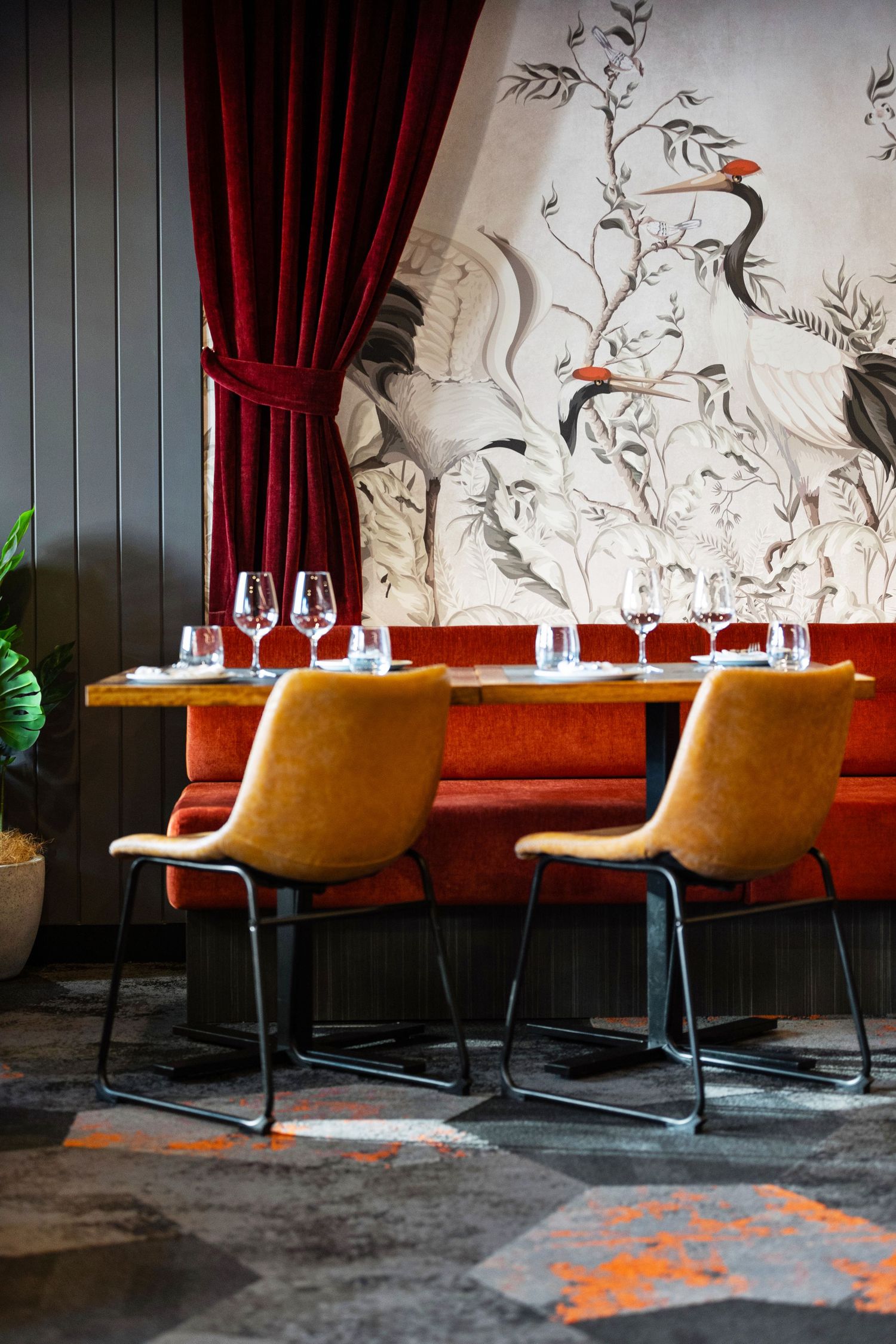 Interior photograph of a bar or restaurant fit-out with velvet booth seating.