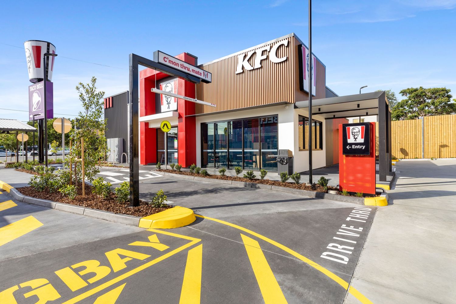 Exterior photograph of a KFC fast food restaurant with drive-through.