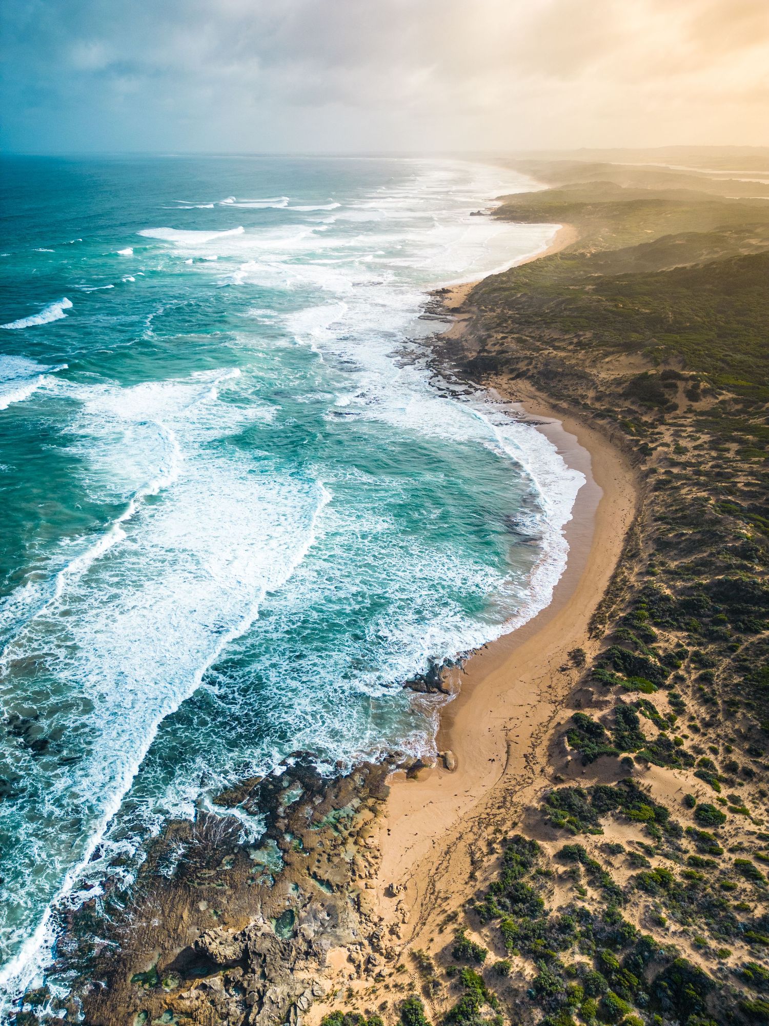 Aerial drone photograph of the Thunder Point coastline with waves breaking on rocky cliffs.