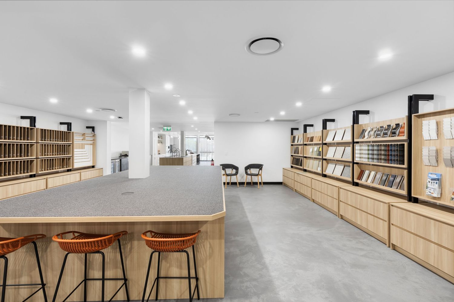 Interior photograph of a retail store fit-out with timber shelving and counter.