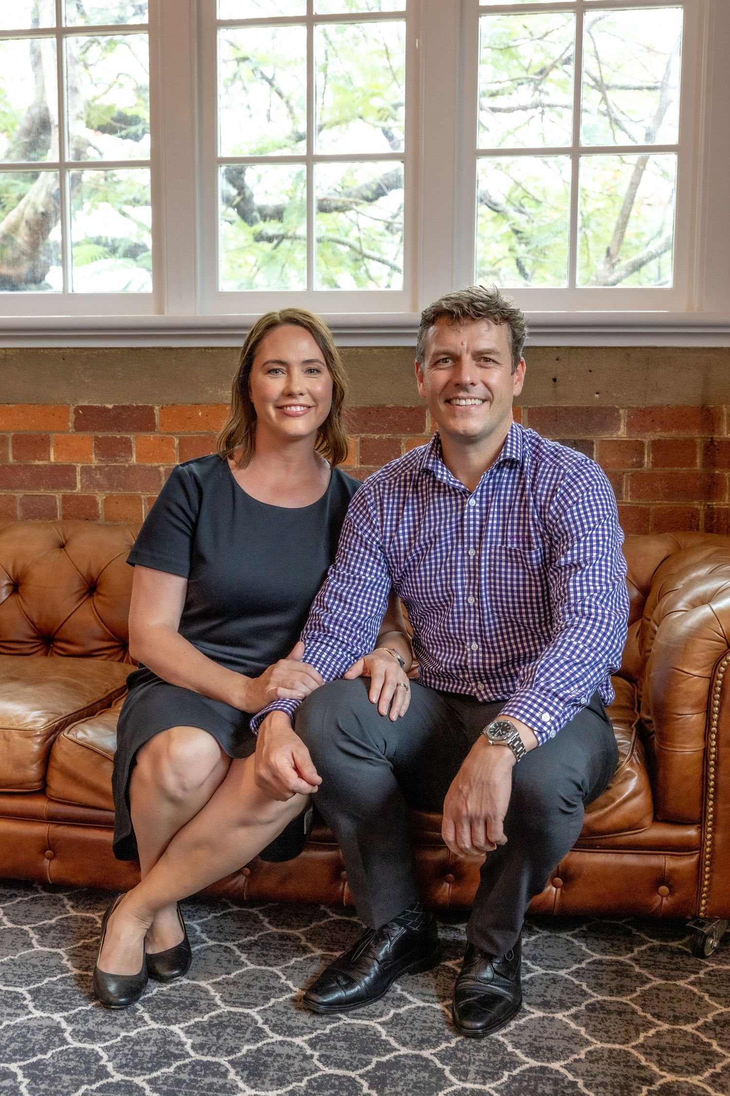 Portrait of Adam and Allison seated together, business branding photography.