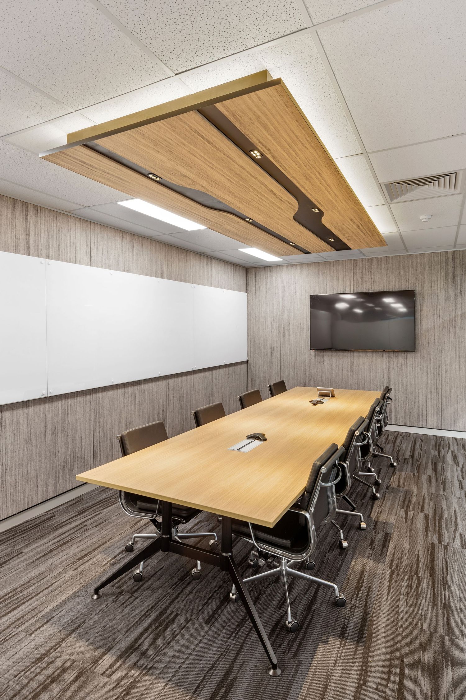 Interior photograph of a corporate boardroom with long timber table.