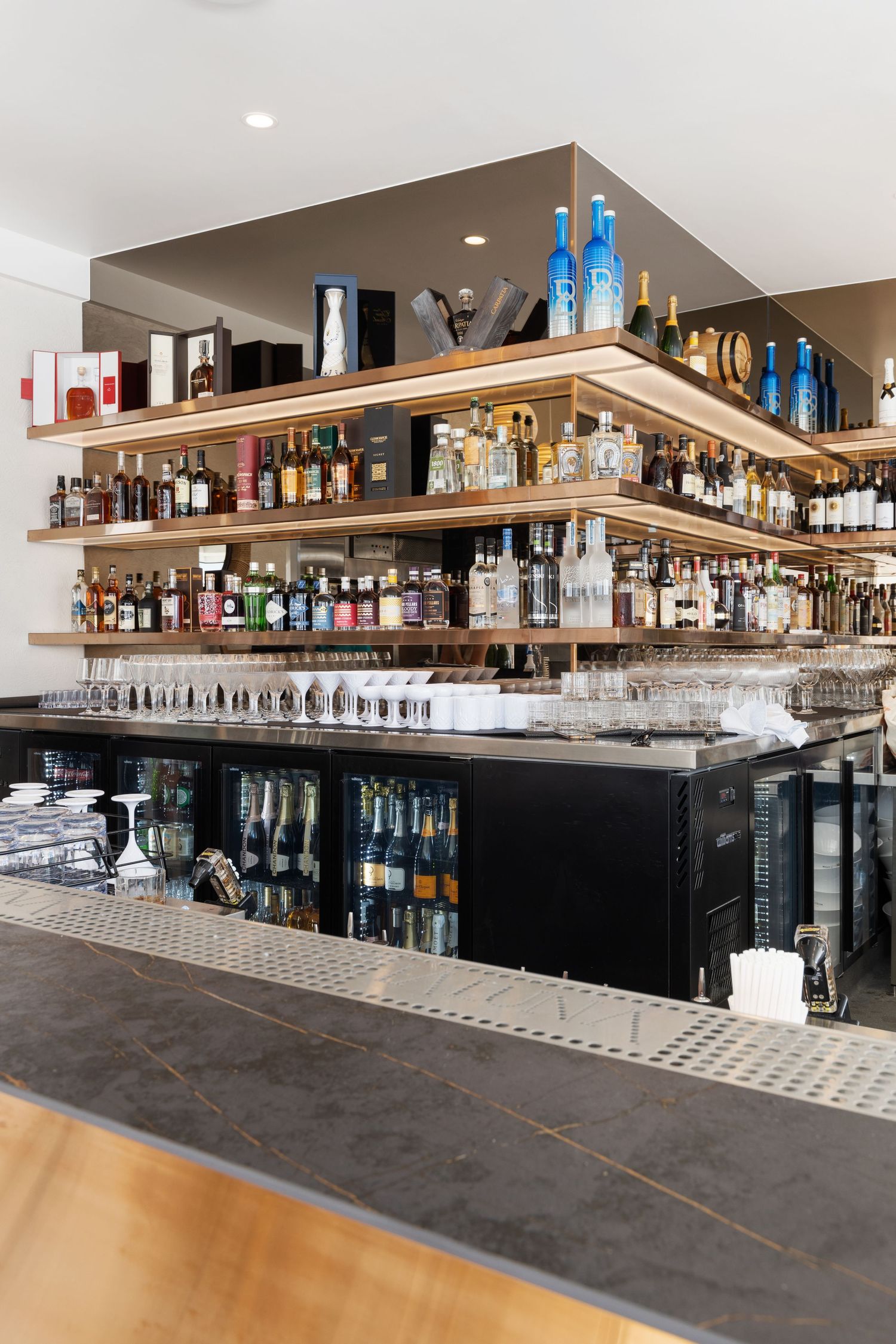 Interior photograph of a bottle shop with wine shelving.