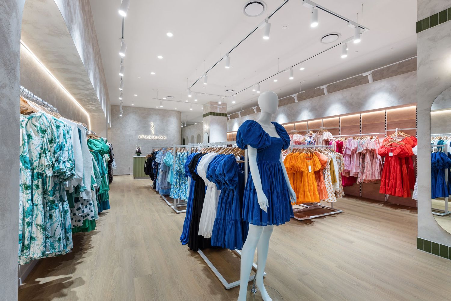 Interior photograph of a clothing retail store with apparel displays.