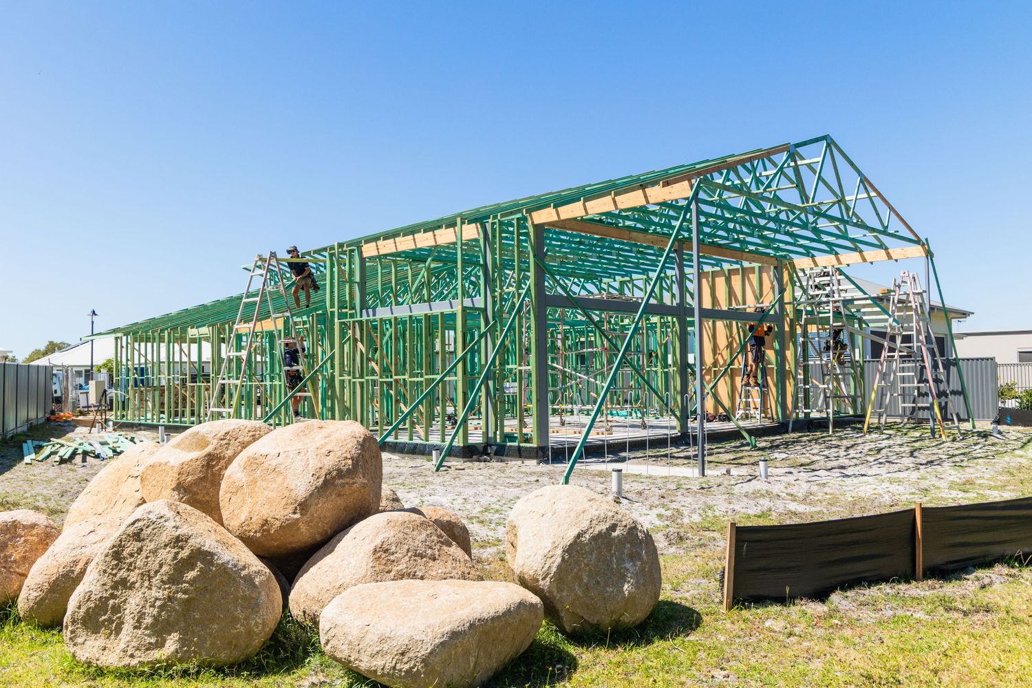 Construction photograph of a timber house frame at Banksia Beach, framing stage.