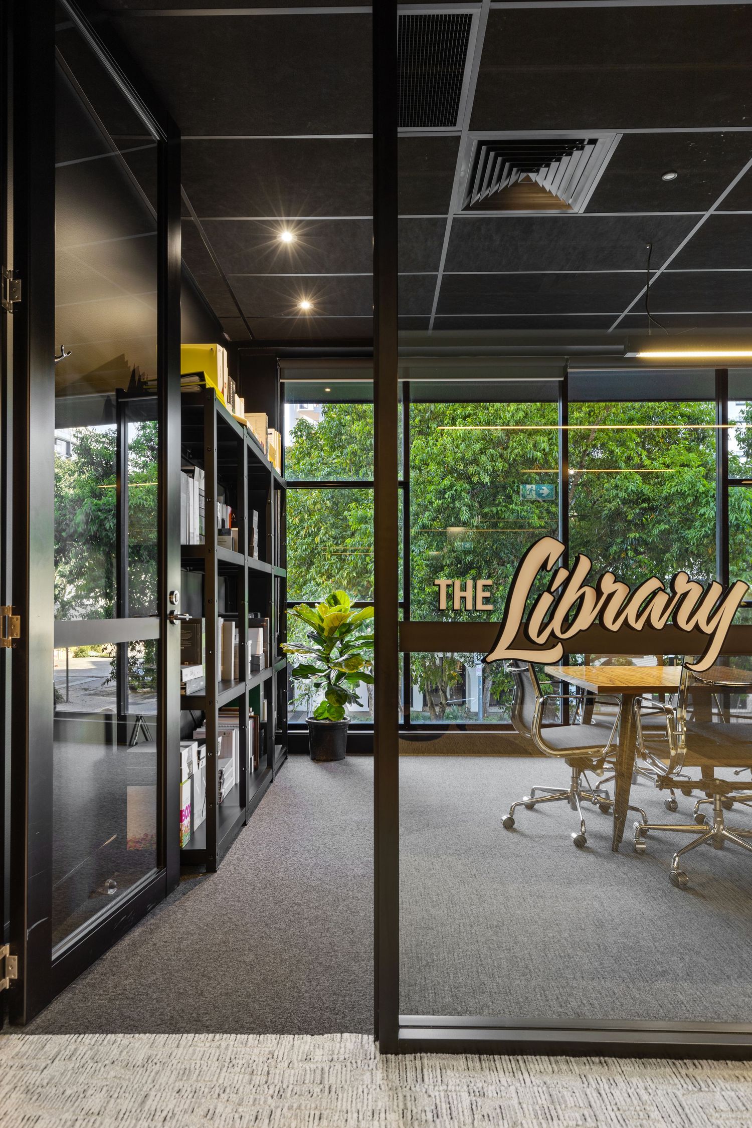 Interior photograph of a storefront entrance with 'Library' signage.