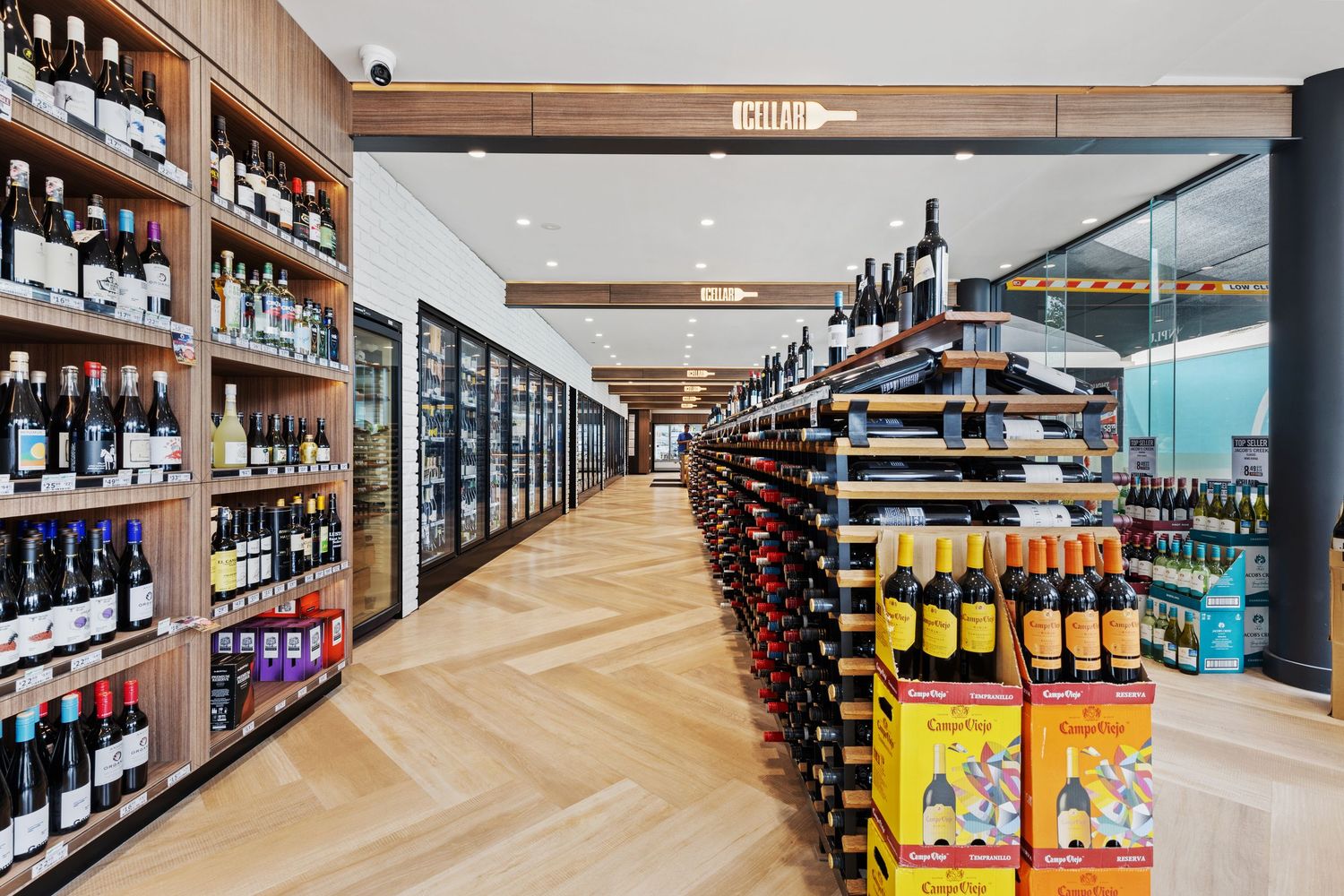 Interior photograph of a bottle shop with wine and spirits aisles.