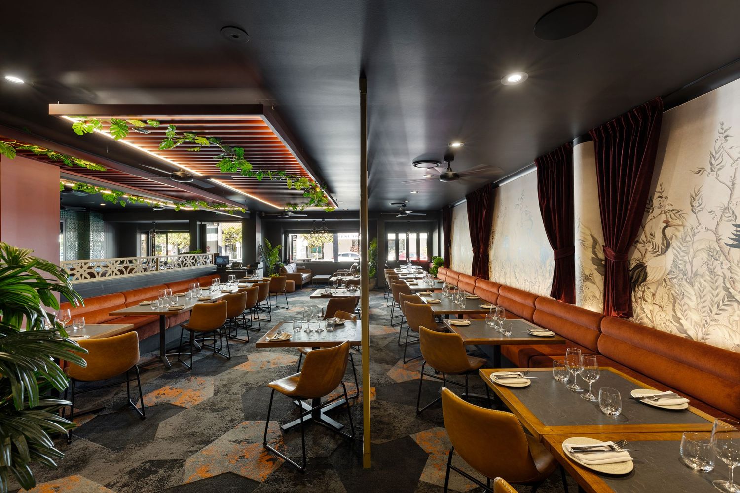 Interior photograph of an elegant restaurant dining room with set tables.