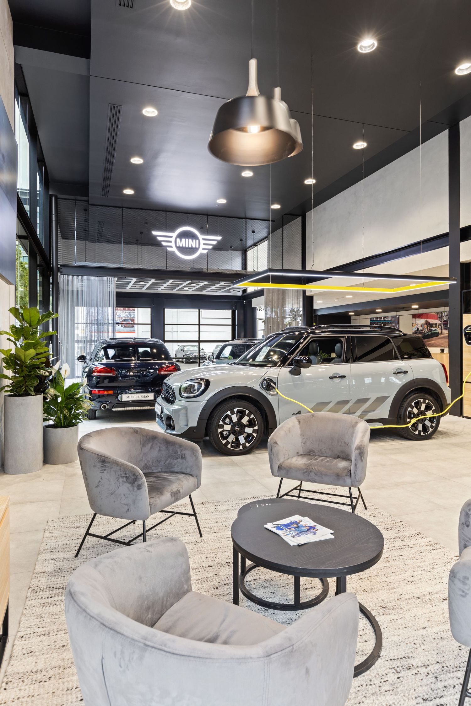 Interior photograph of a MINI car dealership showroom lounge area.