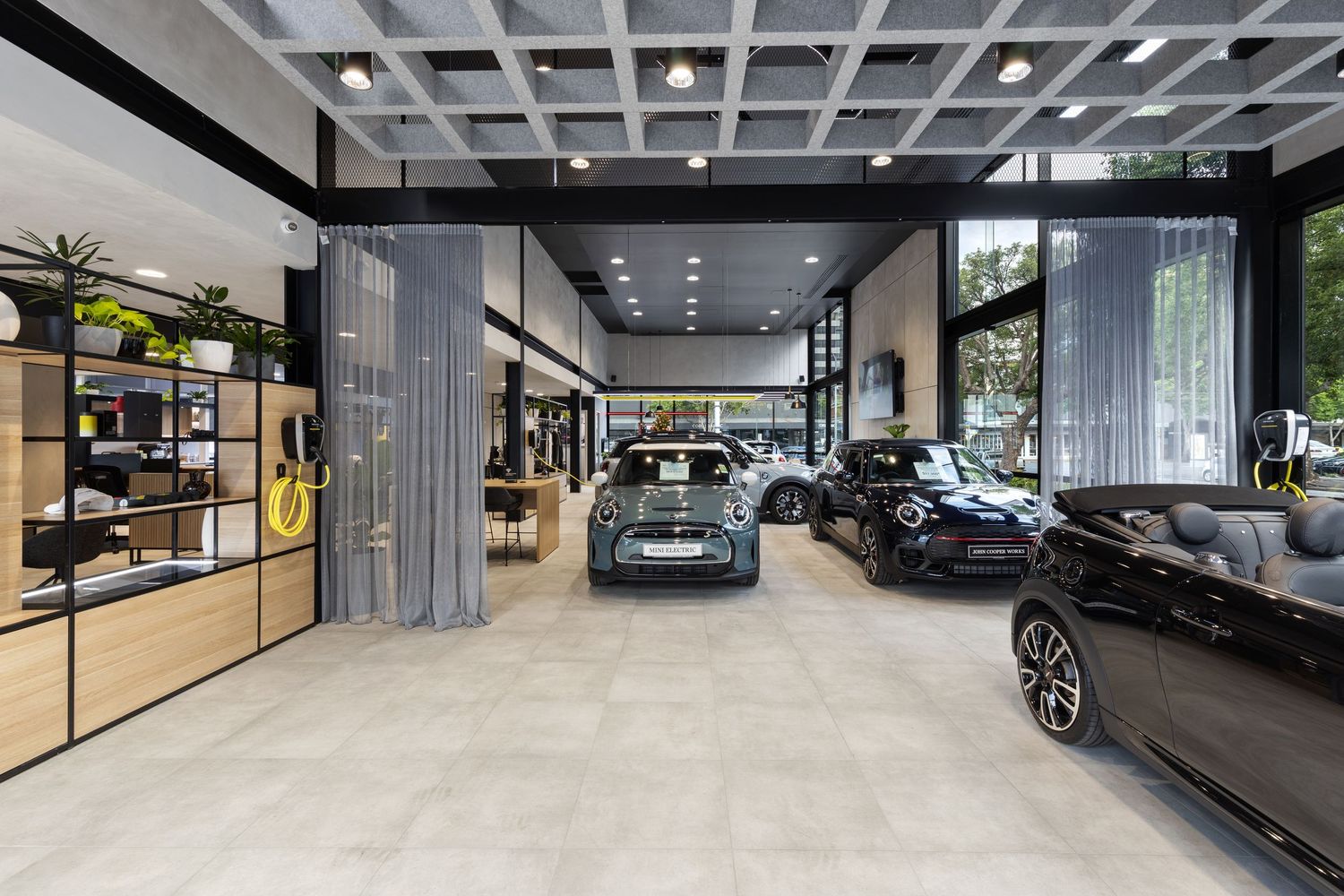 Interior photograph of a car dealership showroom with vehicles on display.