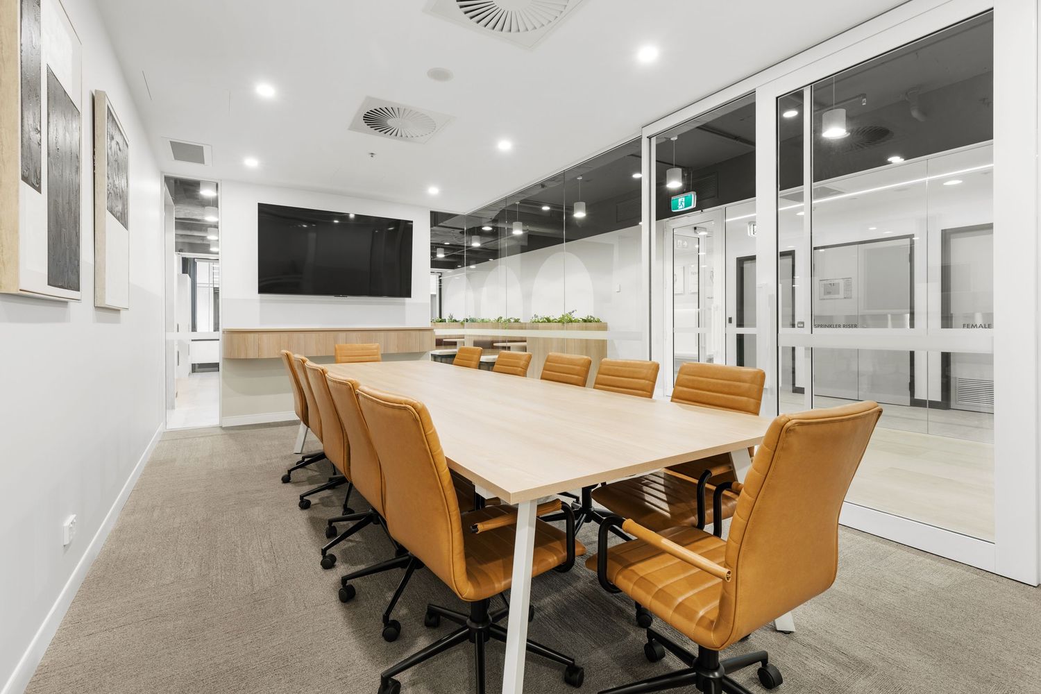Interior photograph of a corporate boardroom with long timber table.