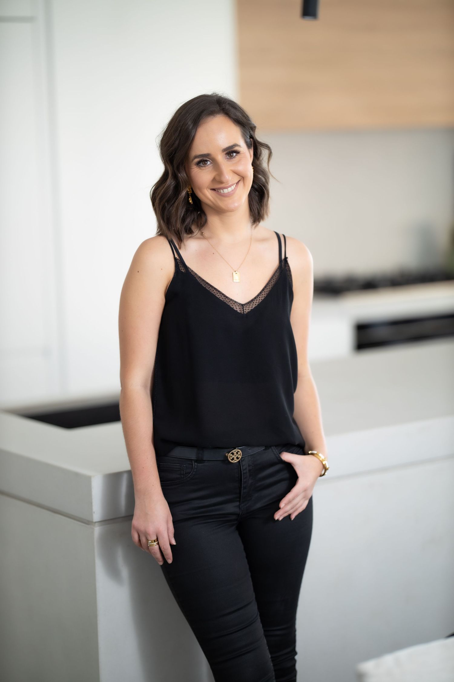Portrait of Lauren standing in a kitchen setting, business branding photography.