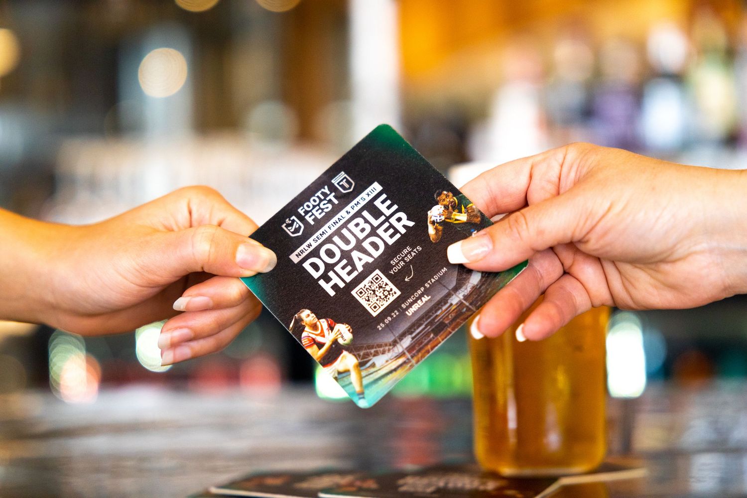 Close-up photograph of a hand holding an event ticket at a bar for Vibez 5ive Senses.
