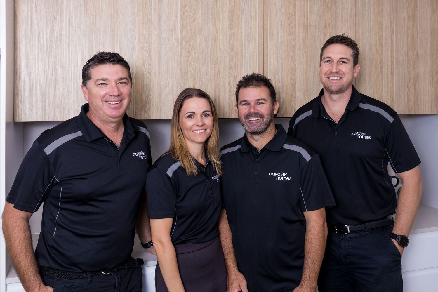Group portrait of the Cavalier Homes Gold Coast team in branded workwear.