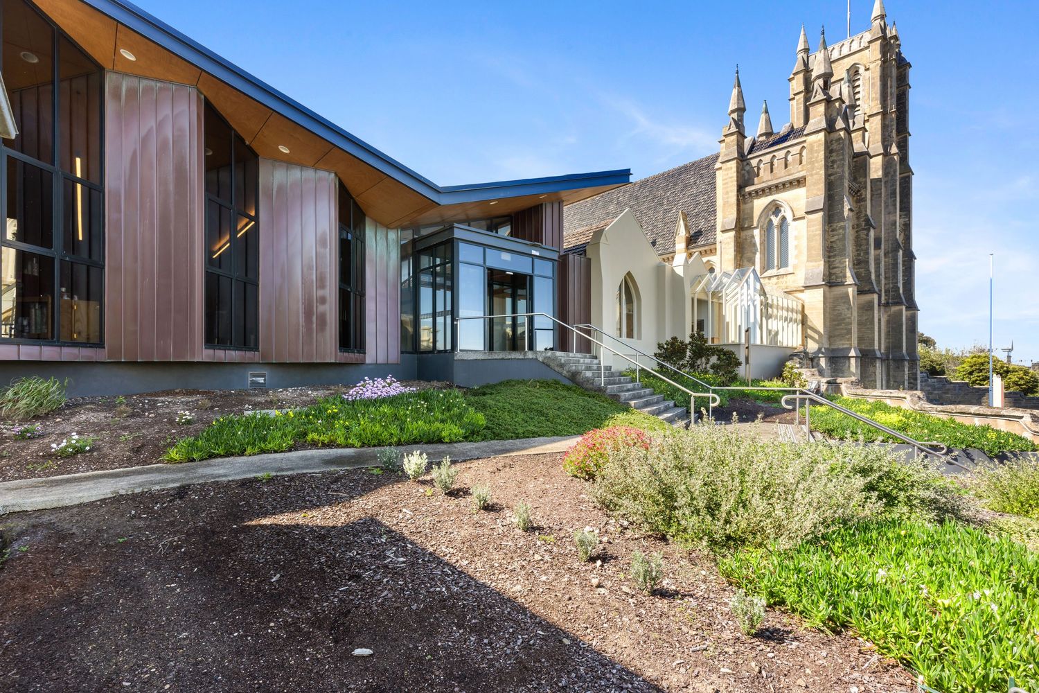 Exterior photograph of a modern community building with landscaped entrance.